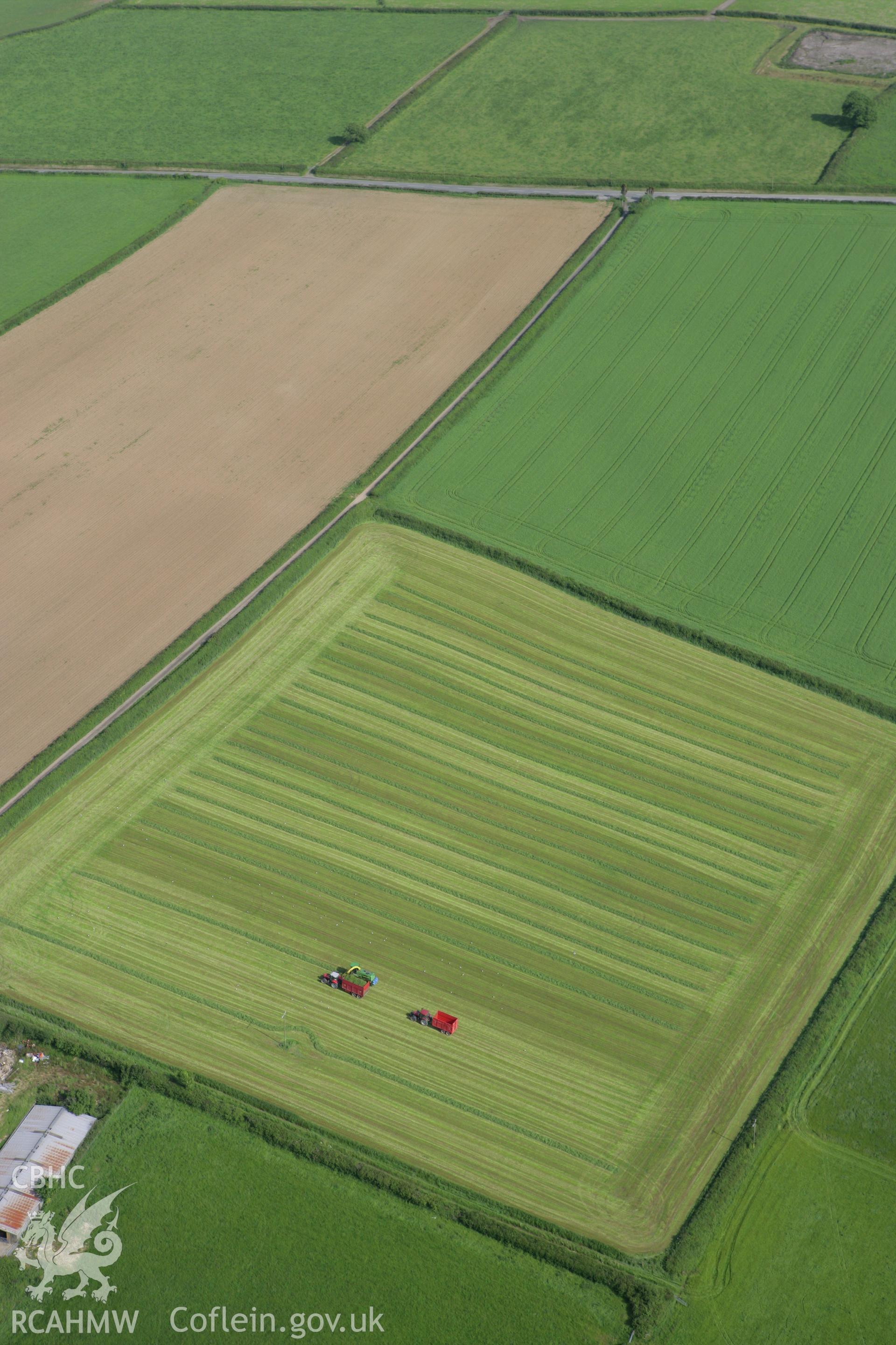 RCAHMW colour oblique photograph of harvesting in fields at Froghall, west of strip field system, Amblestone. Taken by Toby Driver on 13/06/2008.