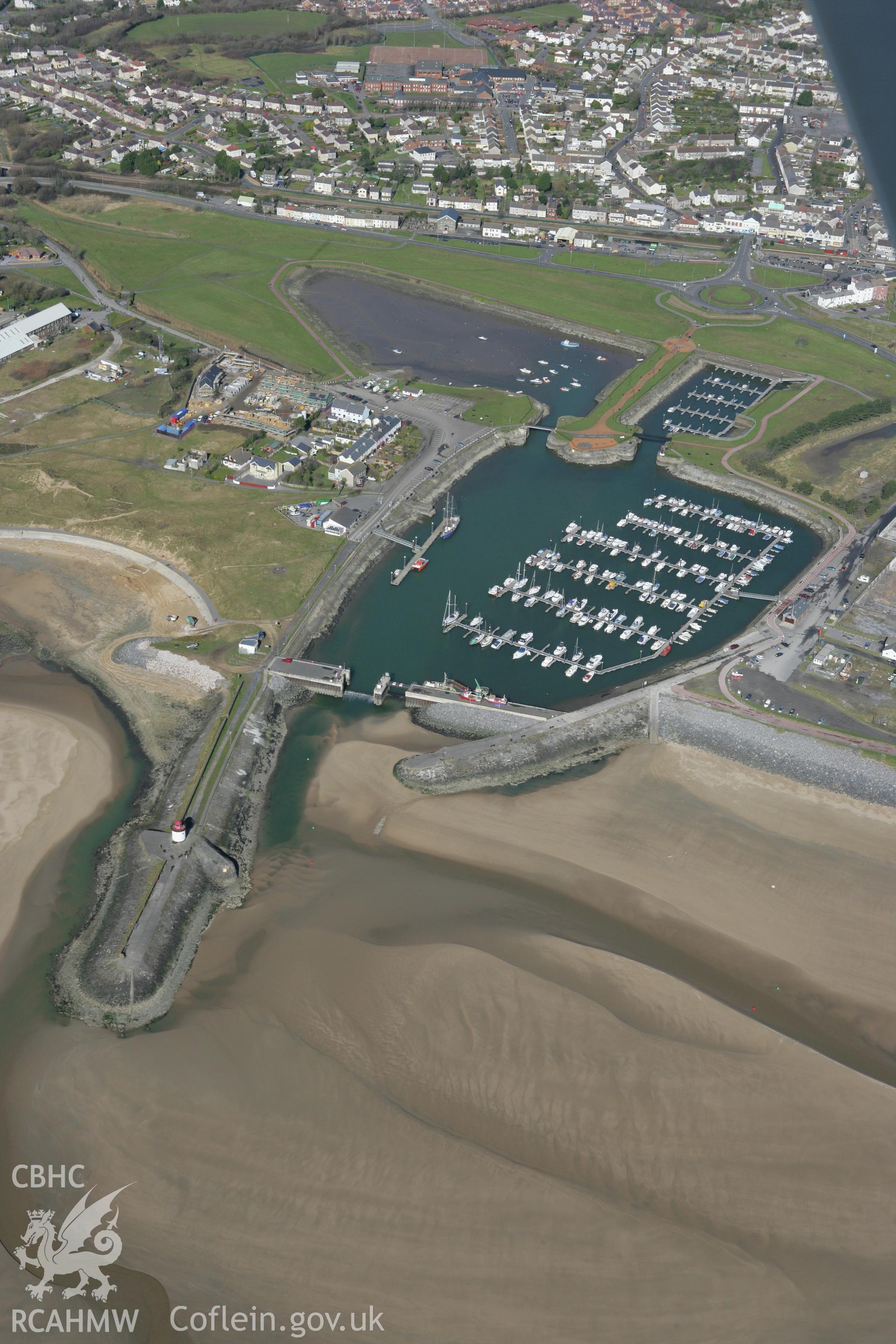 RCAHMW colour oblique photograph of Pembrey New Harbour, with Burry Port Lighthouse and Iron Canal Boats. Taken by Toby Driver on 04/03/2008.