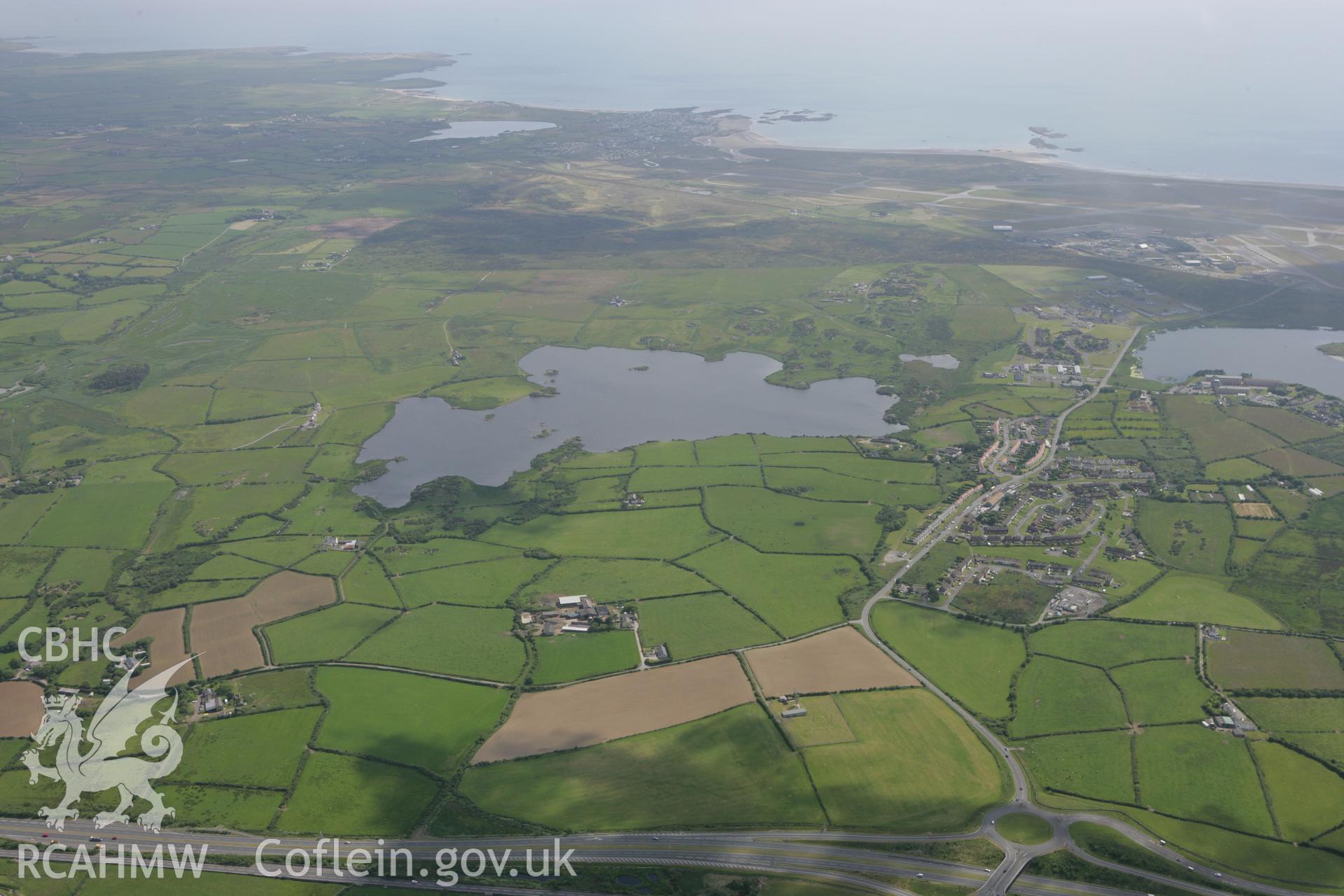 RCAHMW colour oblique photograph of view south over Llyn Traffwll towards Anglesey Airport (Valley Airfield). Taken by Toby Driver on 13/06/2008.