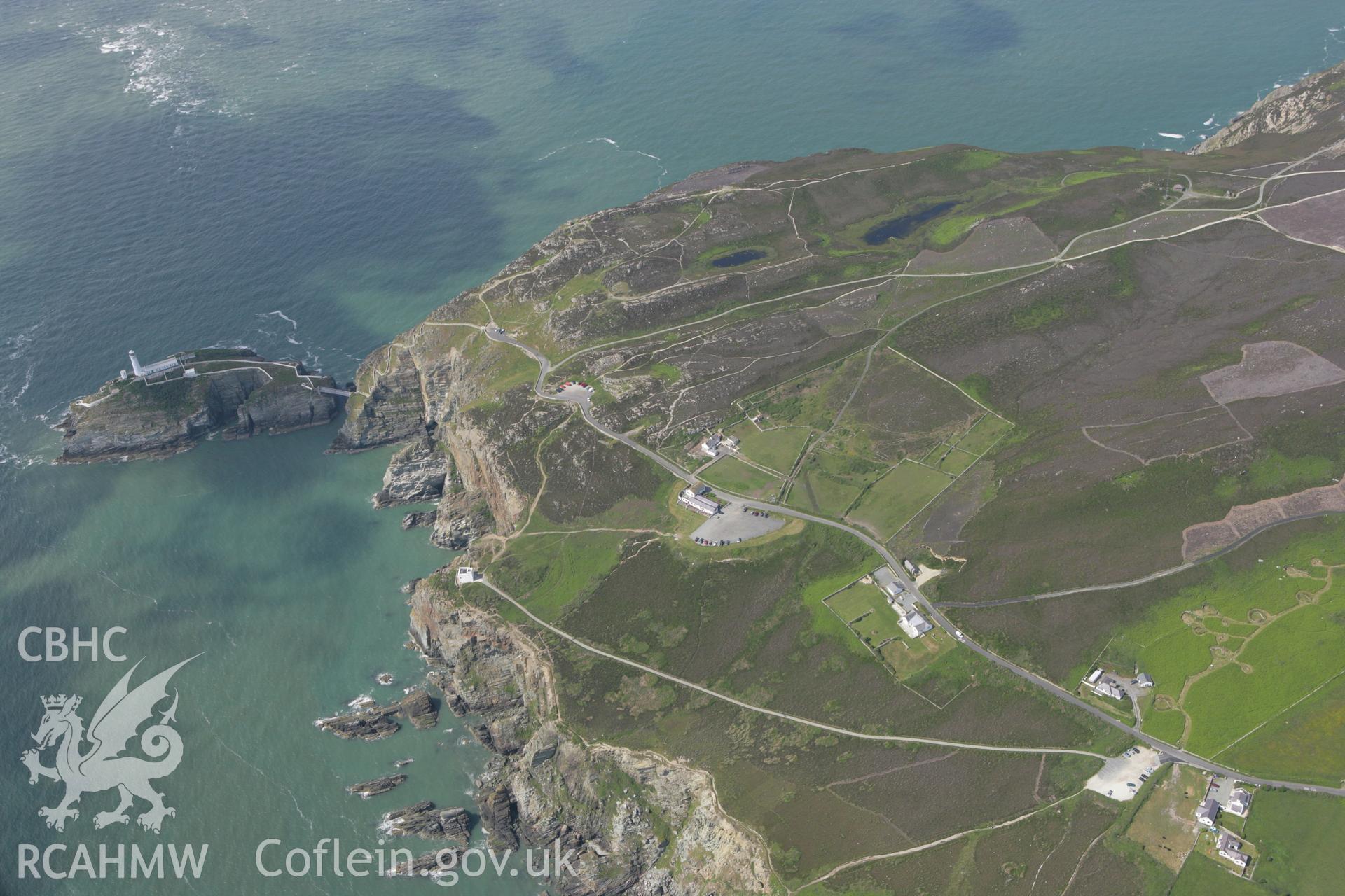 RCAHMW colour oblique photograph of Cytiau'r Gwyddelod, Holyhead Mountain Settlement Complex, with South Stack Lighthouse to the west. Taken by Toby Driver on 13/06/2008.