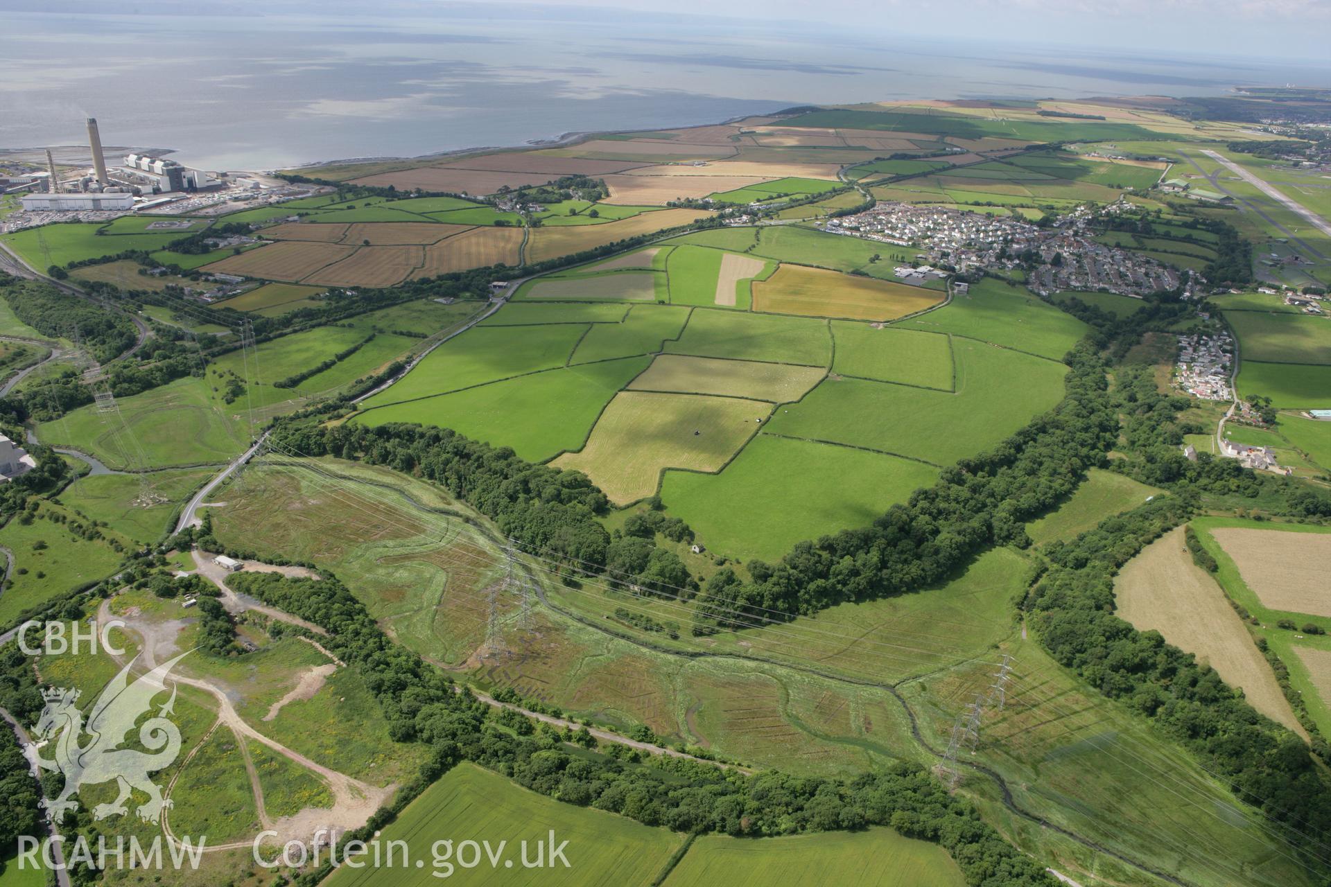 RCAHMW colour oblique photograph of East Orchard Castle Barn and Dovecote, with St Athan and Aberthaw Power Station in the distance. Taken by Toby Driver on 21/07/2008.