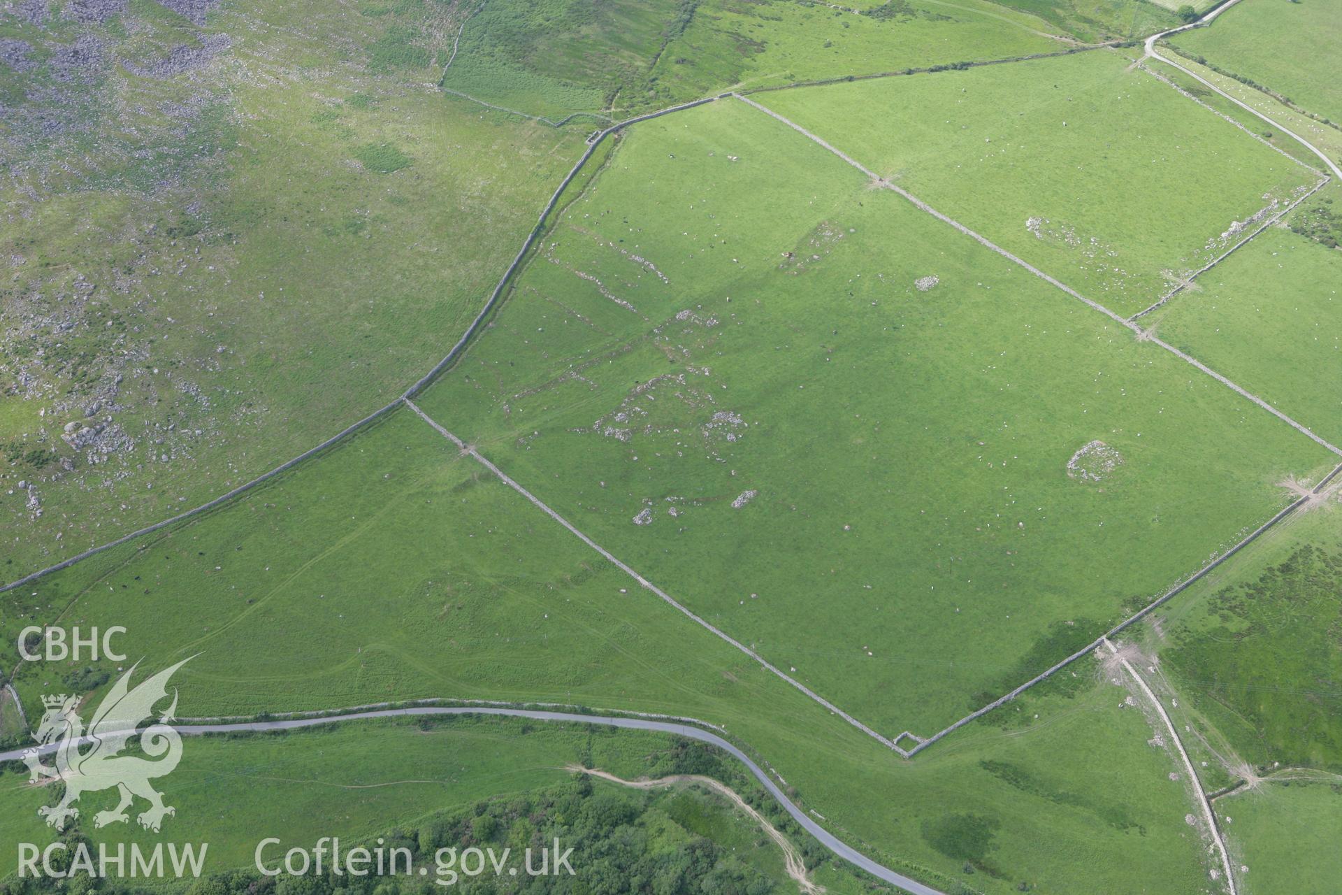 RCAHMW colour oblique photograph of Caerau-uchaf Enclosed Settlement, with Pen-y-caerau Field System. Taken by Toby Driver on 13/06/2008.