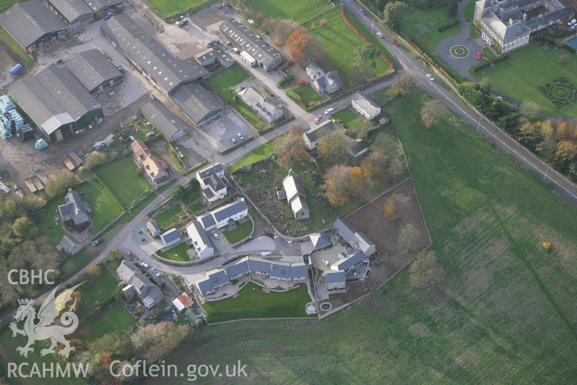 RCAHMW colour oblique photograph of St Tudwg's Church, with churchyard cross. Taken by Toby Driver on 12/11/2008.