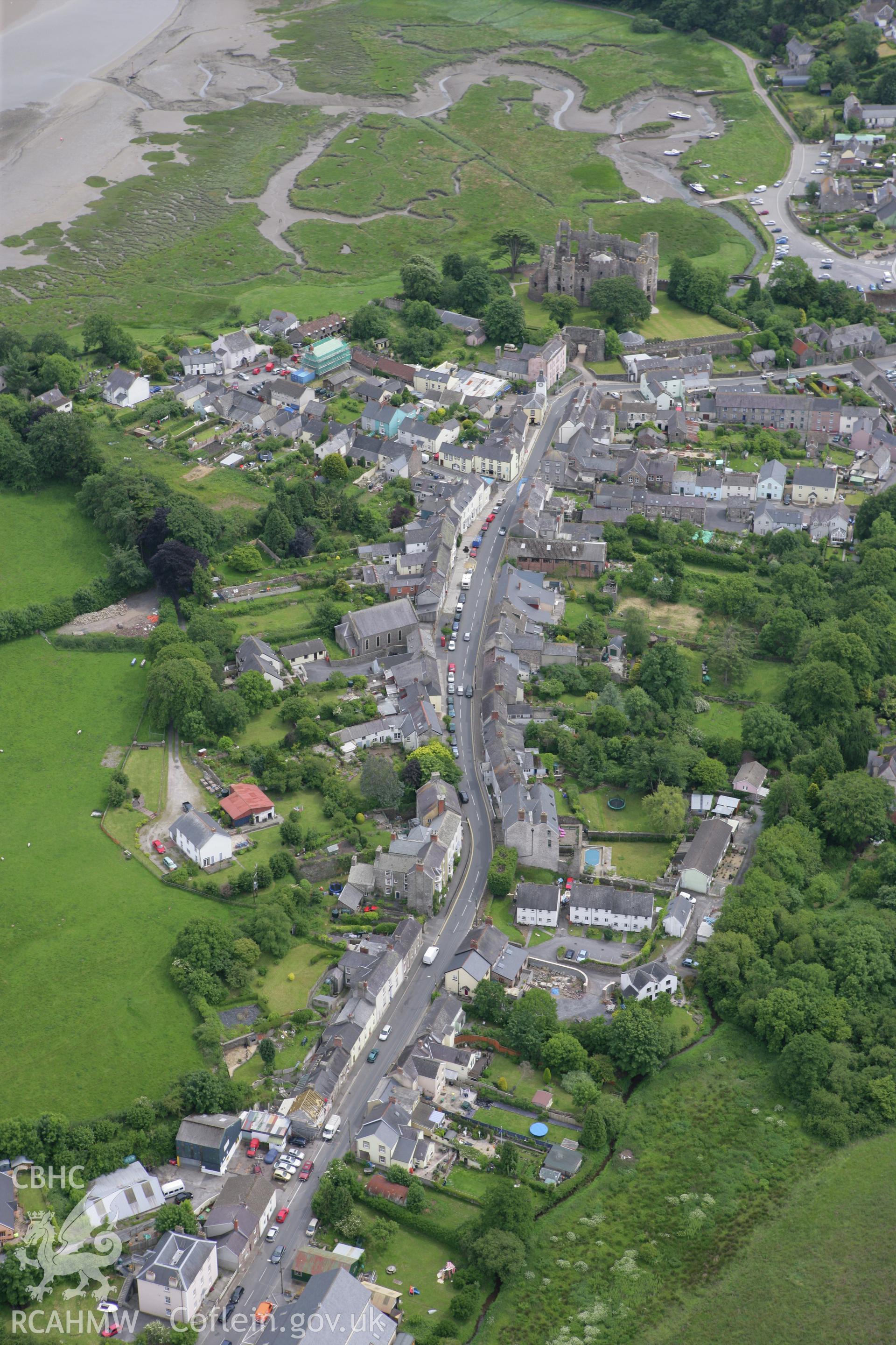 RCAHMW colour oblique photograph of Laugharne, view of town with Laugharne Castle. Taken by Toby Driver on 20/06/2008.