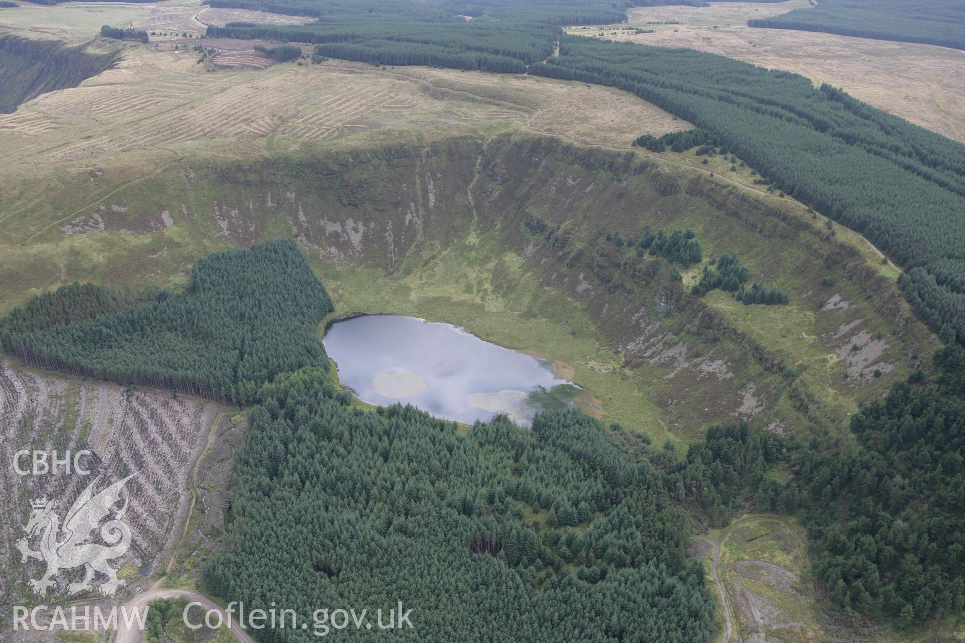 RCAHMW colour oblique photograph of Llyn Fach, with the site of Garn Fach Cairn (under woodland). Taken by Toby Driver on 12/09/2008.