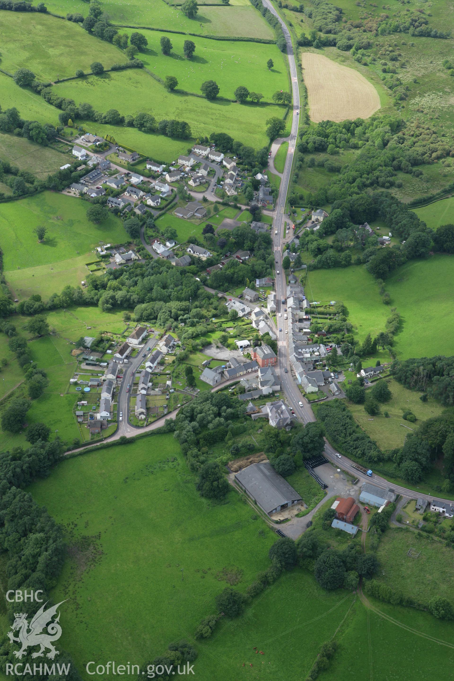 RCAHMW colour oblique aerial photograph of Trecastle Motte and the village. Taken on 09 July 2007 by Toby Driver