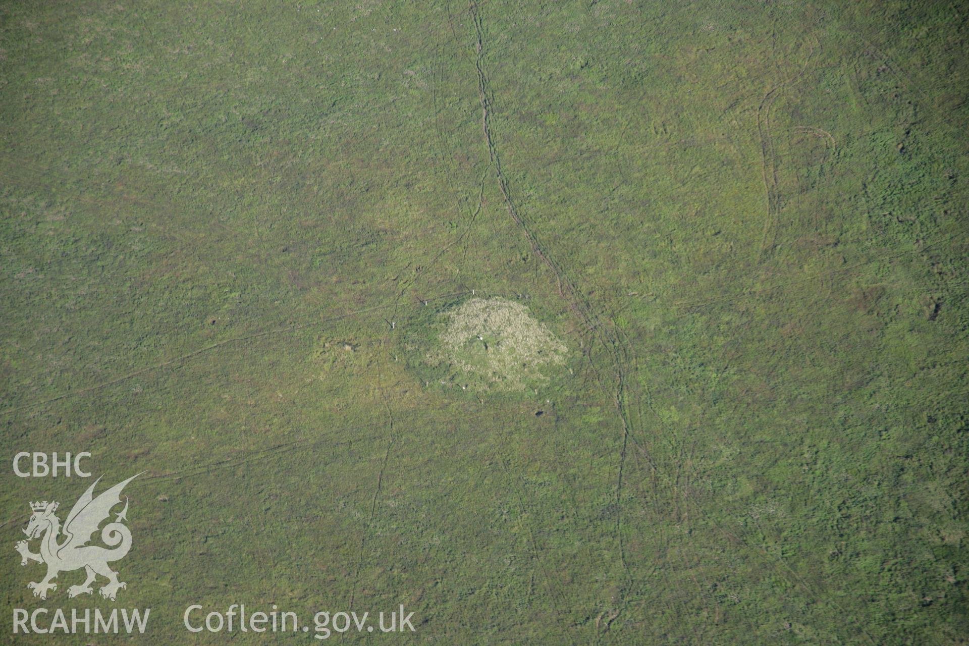 RCAHMW colour oblique aerial photograph of Bryn Melin Cairn, Llandeilor Fan. Taken on 08 August 2007 by Toby Driver