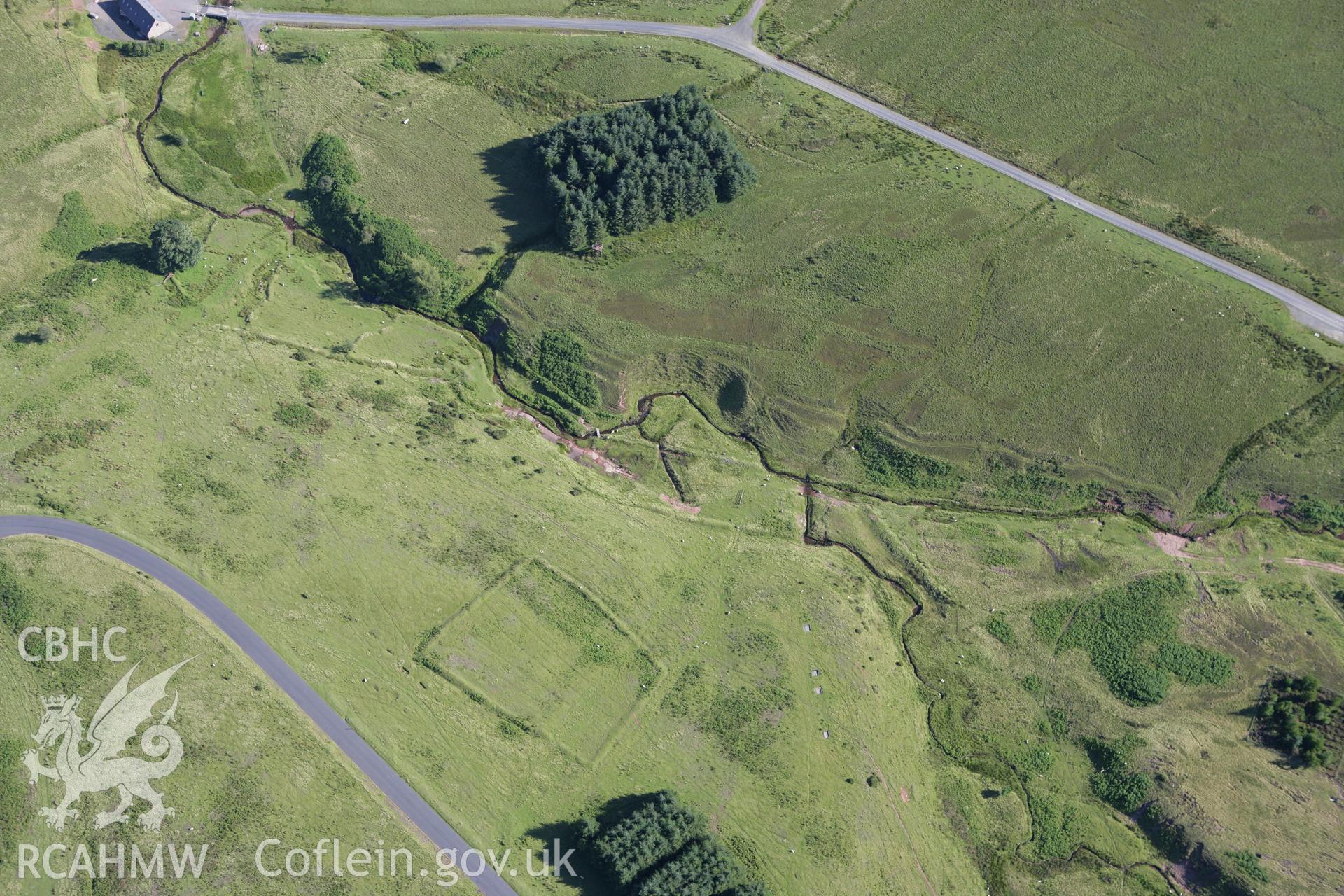 RCAHMW colour oblique aerial photograph of Pentre Dolau Honddu Enclosure. Taken on 08 August 2007 by Toby Driver