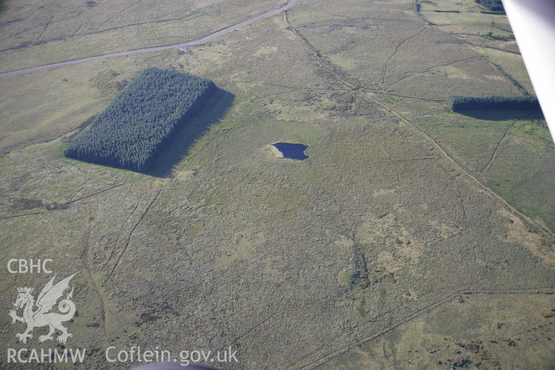 RCAHMW colour oblique aerial photograph of a cairn to the southeast of Llyn Nant Llys. Taken on 08 August 2007 by Toby Driver