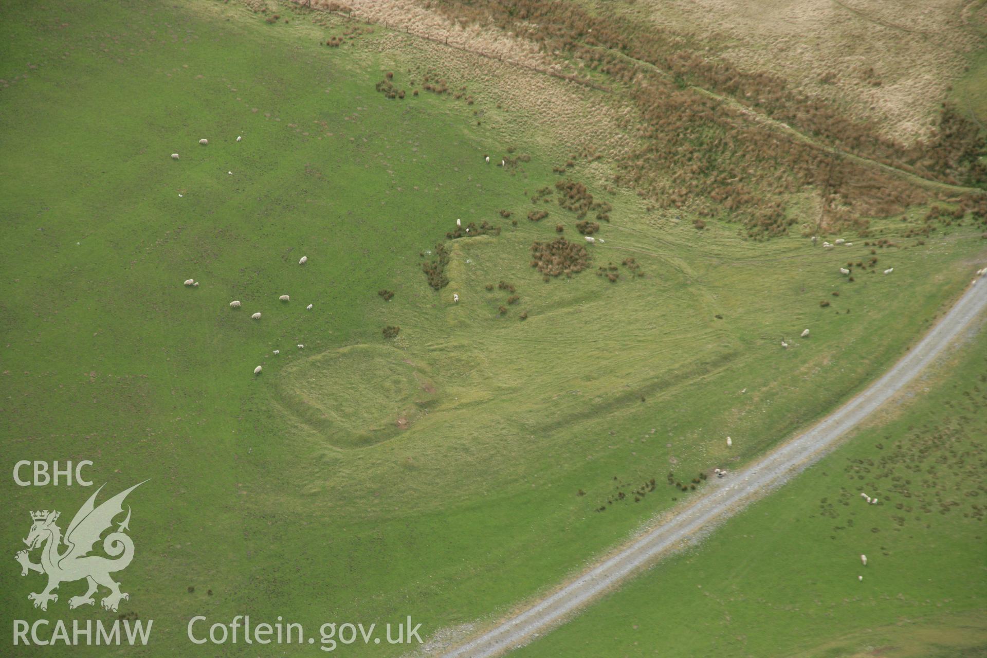 RCAHMW colour oblique aerial photograph of Banc Pwlldrainllwyn Enclosure. Taken on 17 April 2007 by Toby Driver