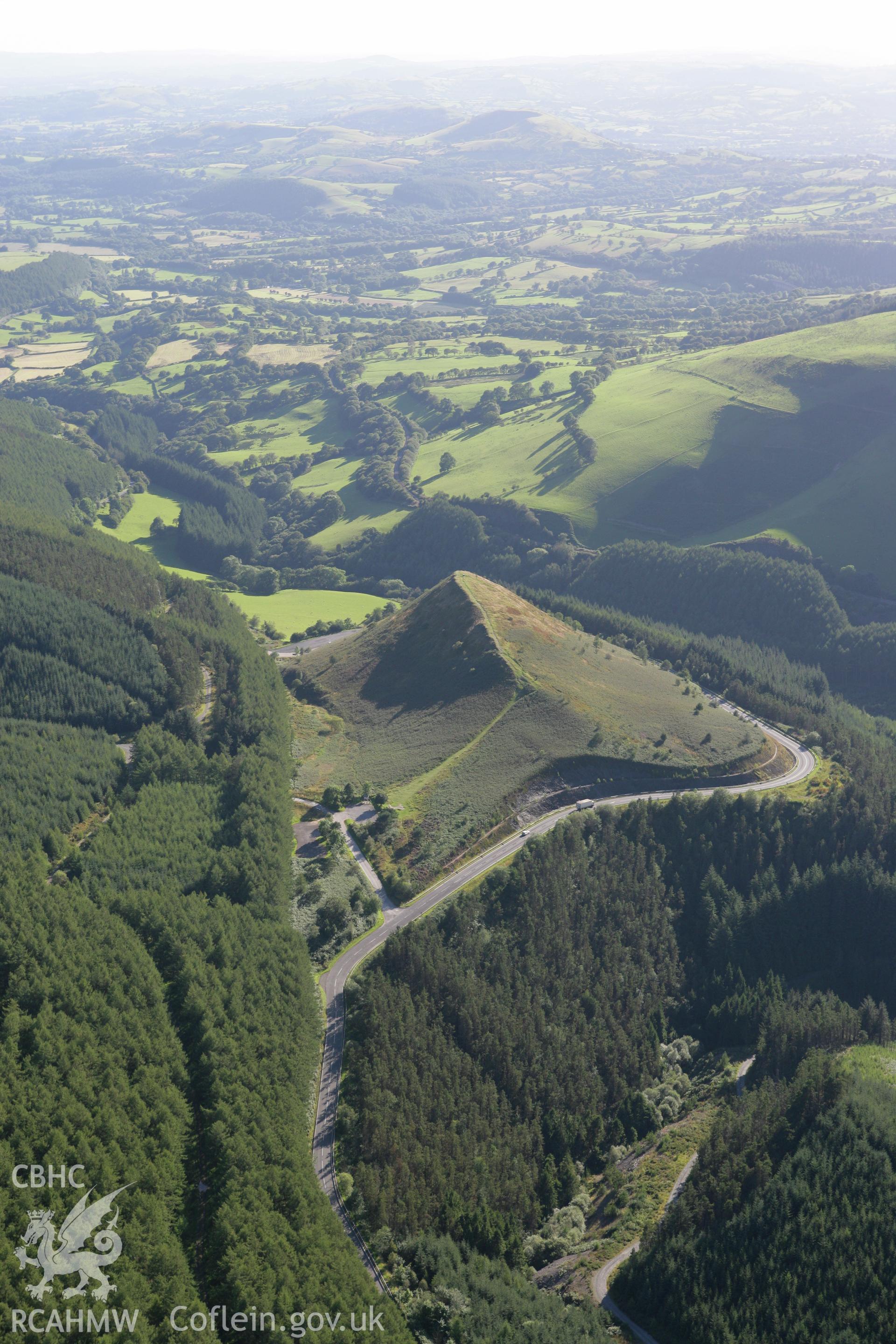 RCAHMW colour oblique aerial photograph of Sugar Loaf Hillfort. Taken on 08 August 2007 by Toby Driver