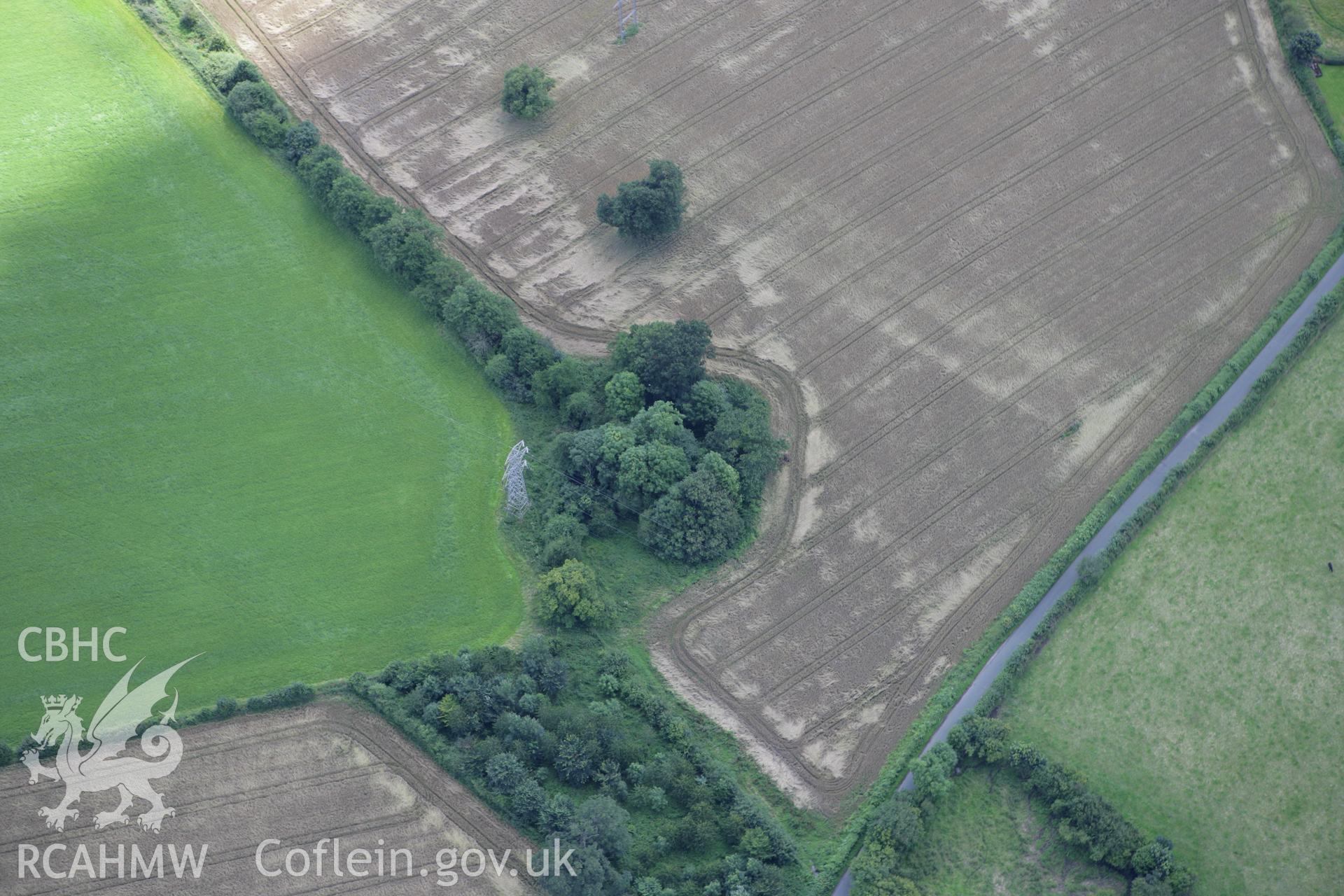 RCAHMW colour oblique aerial photograph of Llyntro Moat, Rhostyllen. Taken on 24 July 2007 by Toby Driver