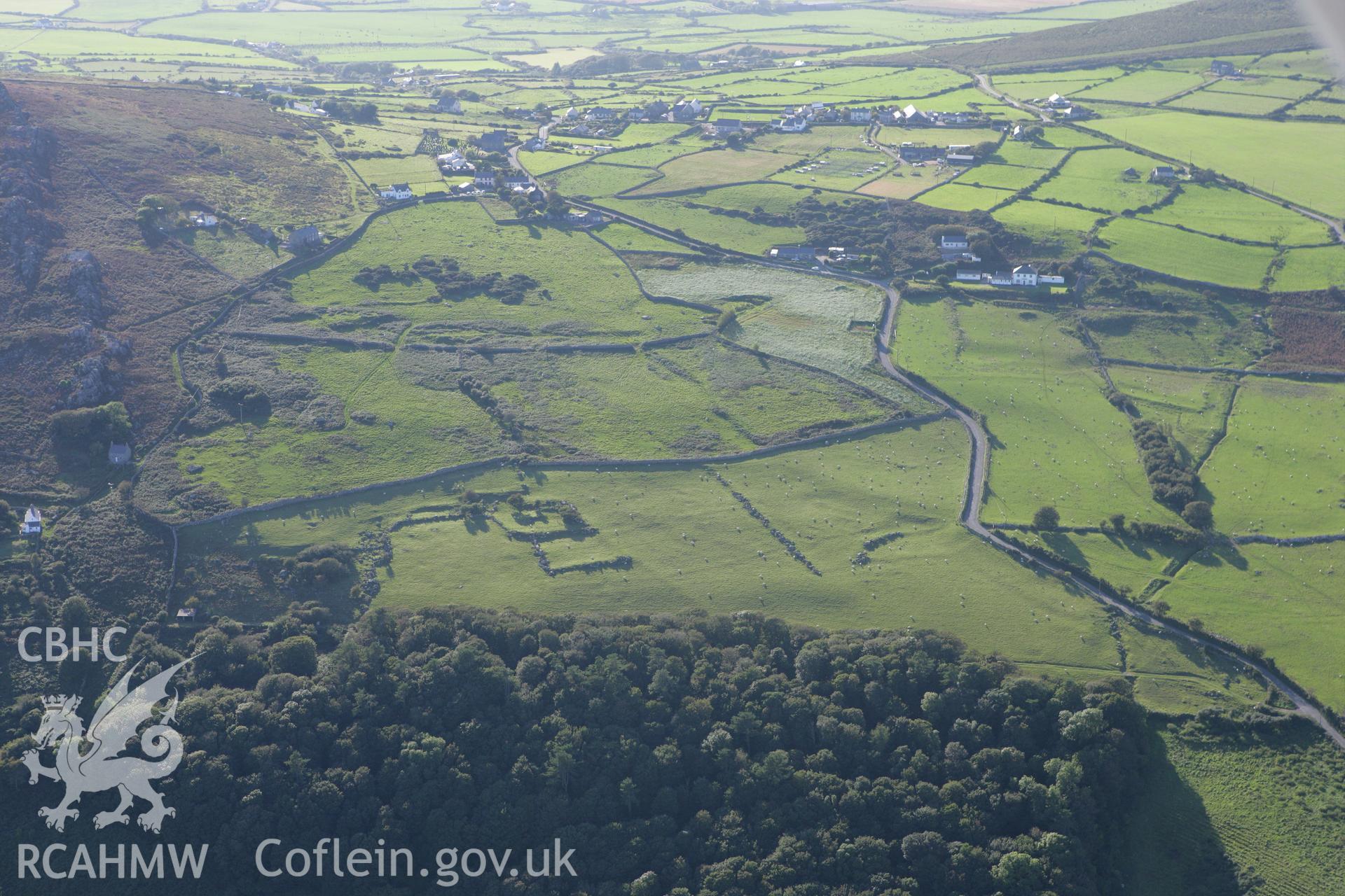 RCAHMW colour oblique aerial photograph of a hut circle south of Rhiw. Taken on 06 September 2007 by Toby Driver