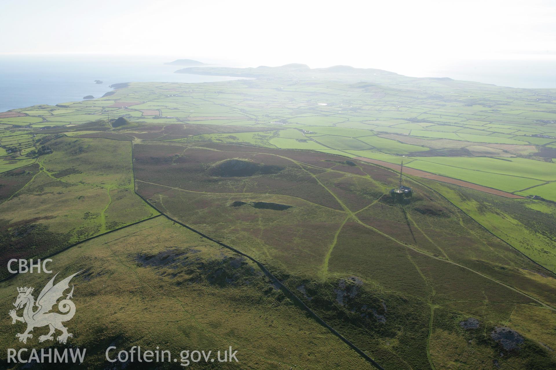 RCAHMW colour oblique aerial photograph showing landscape of Neolithic Axe Factory, Mynydd Rhiw. Taken on 06 September 2007 by Toby Driver