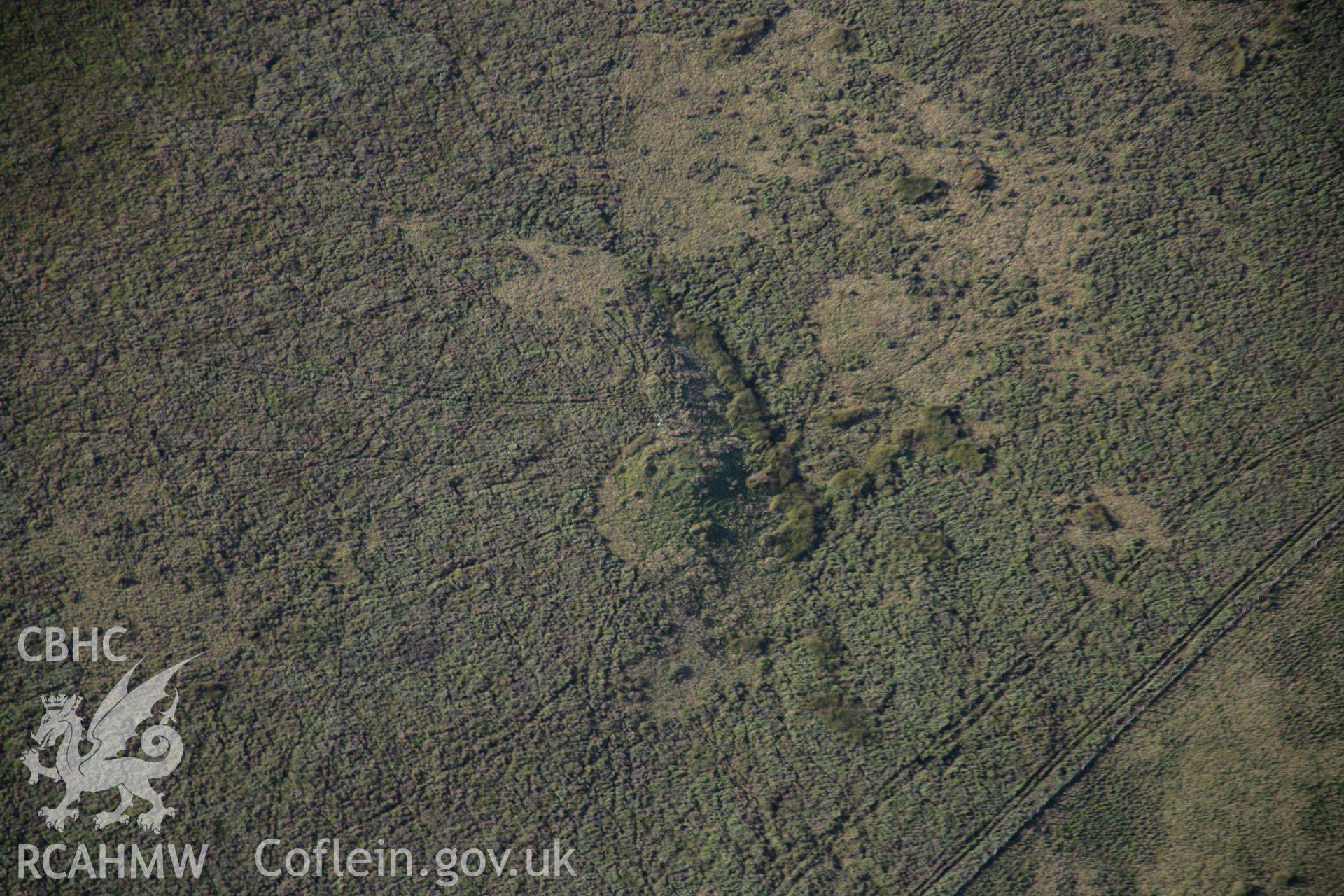 RCAHMW colour oblique aerial photograph of a cairn to the southeast of Llyn Nant Llys. Taken on 08 August 2007 by Toby Driver