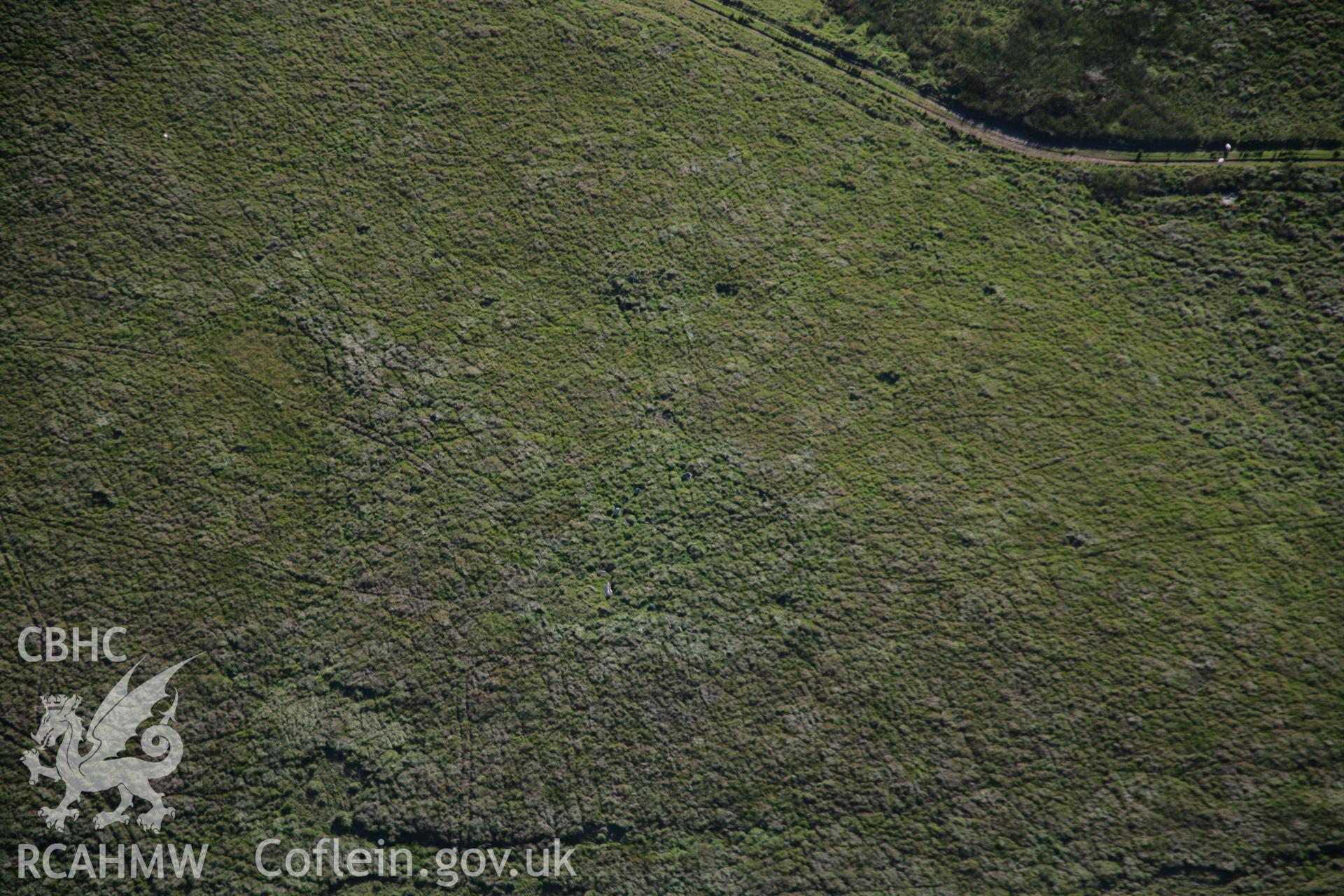 RCAHMW colour oblique aerial photograph of a stone circle west of Ynyshir. Taken on 08 August 2007 by Toby Driver