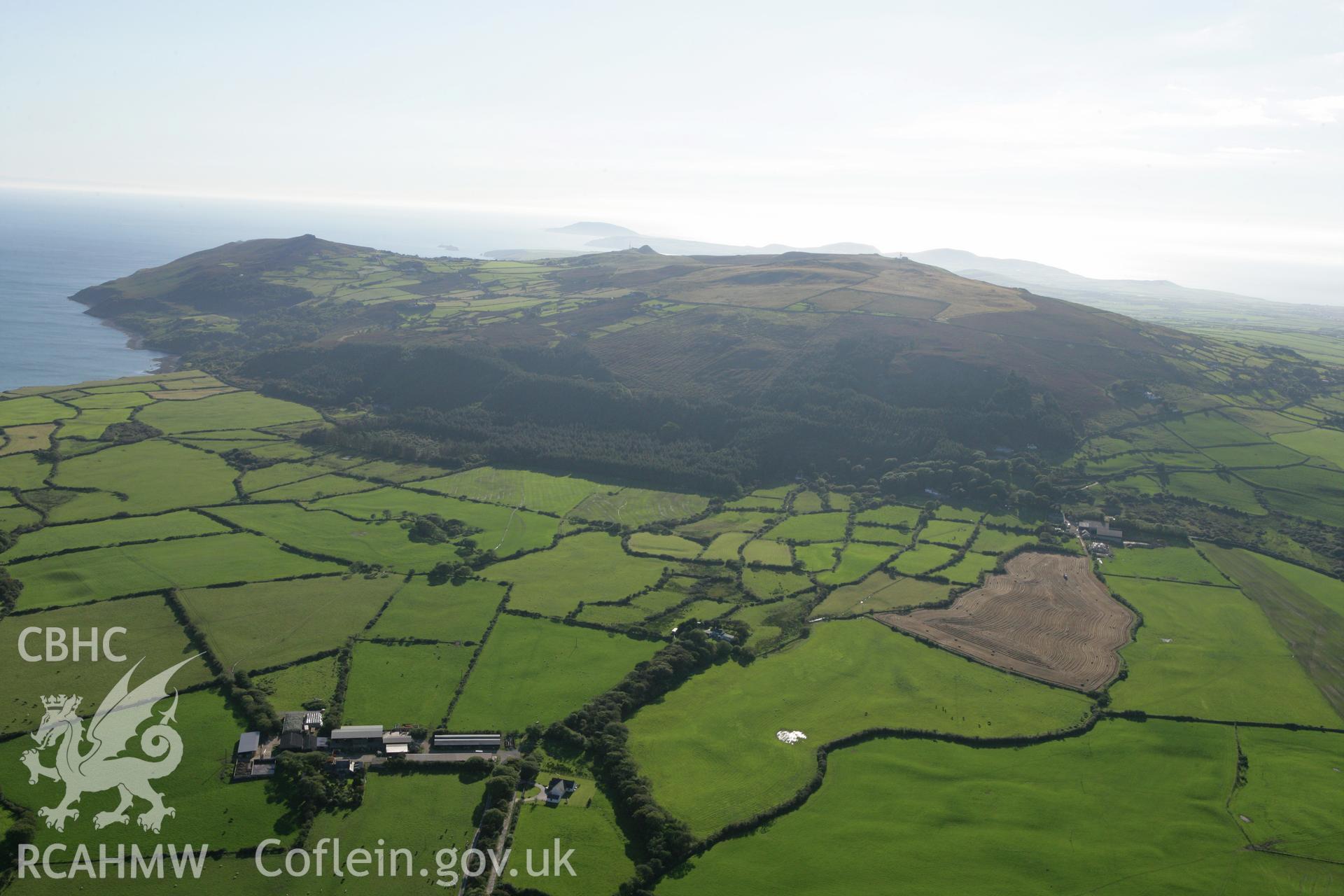 RCAHMW colour oblique aerial photograph showing landscape of Neolithic Axe Factory, Mynydd Rhiw, viewed from the north-east. Taken on 06 September 2007 by Toby Driver