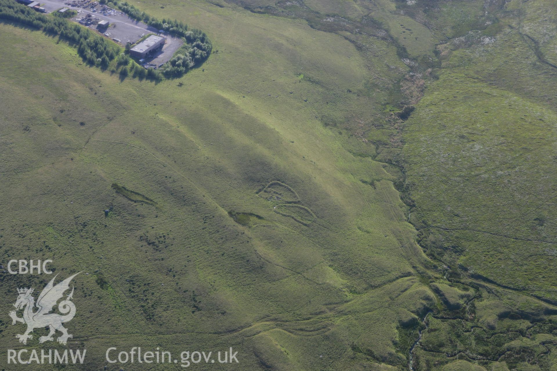 RCAHMW colour oblique aerial photograph of a deserted farmstead south of Ffynnon Yr Oerfa. Taken on 08 August 2007 by Toby Driver