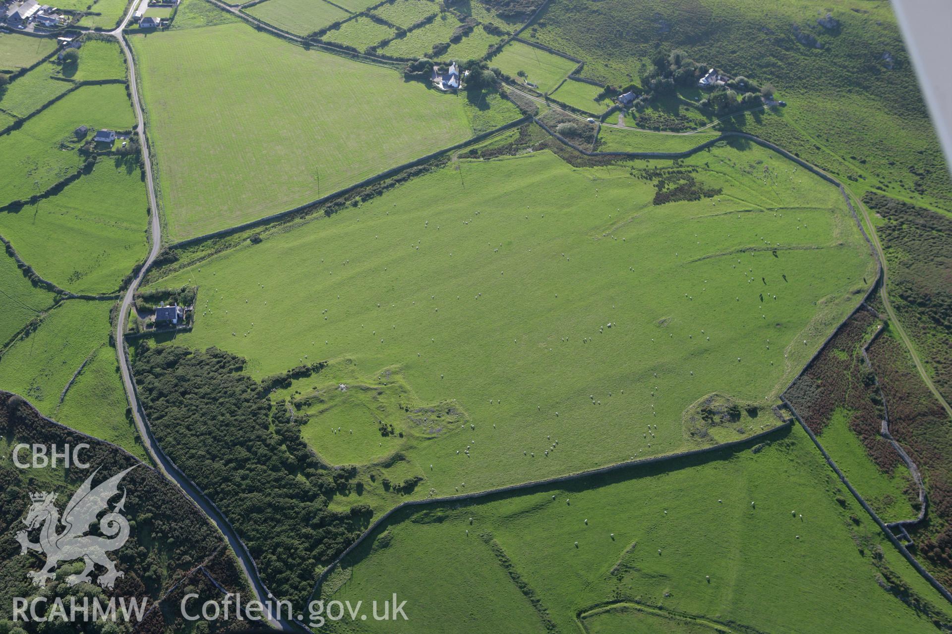 RCAHMW colour oblique aerial photograph of Rhiw Defended Enclosure. Taken on 06 September 2007 by Toby Driver