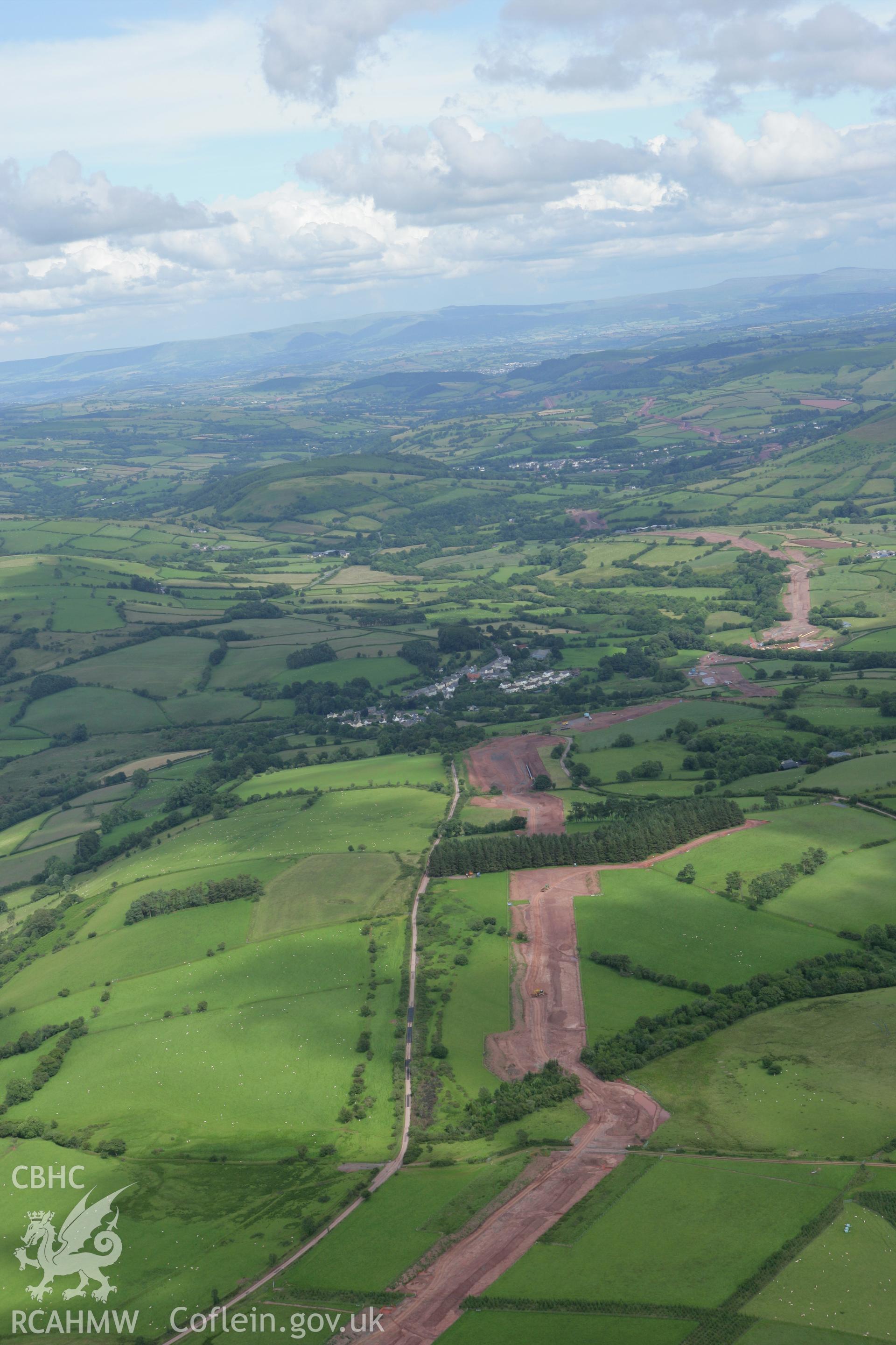 RCAHMW colour oblique aerial photograph of Trecastle with the LNG pipeline passing to the south. Taken on 09 July 2007 by Toby Driver