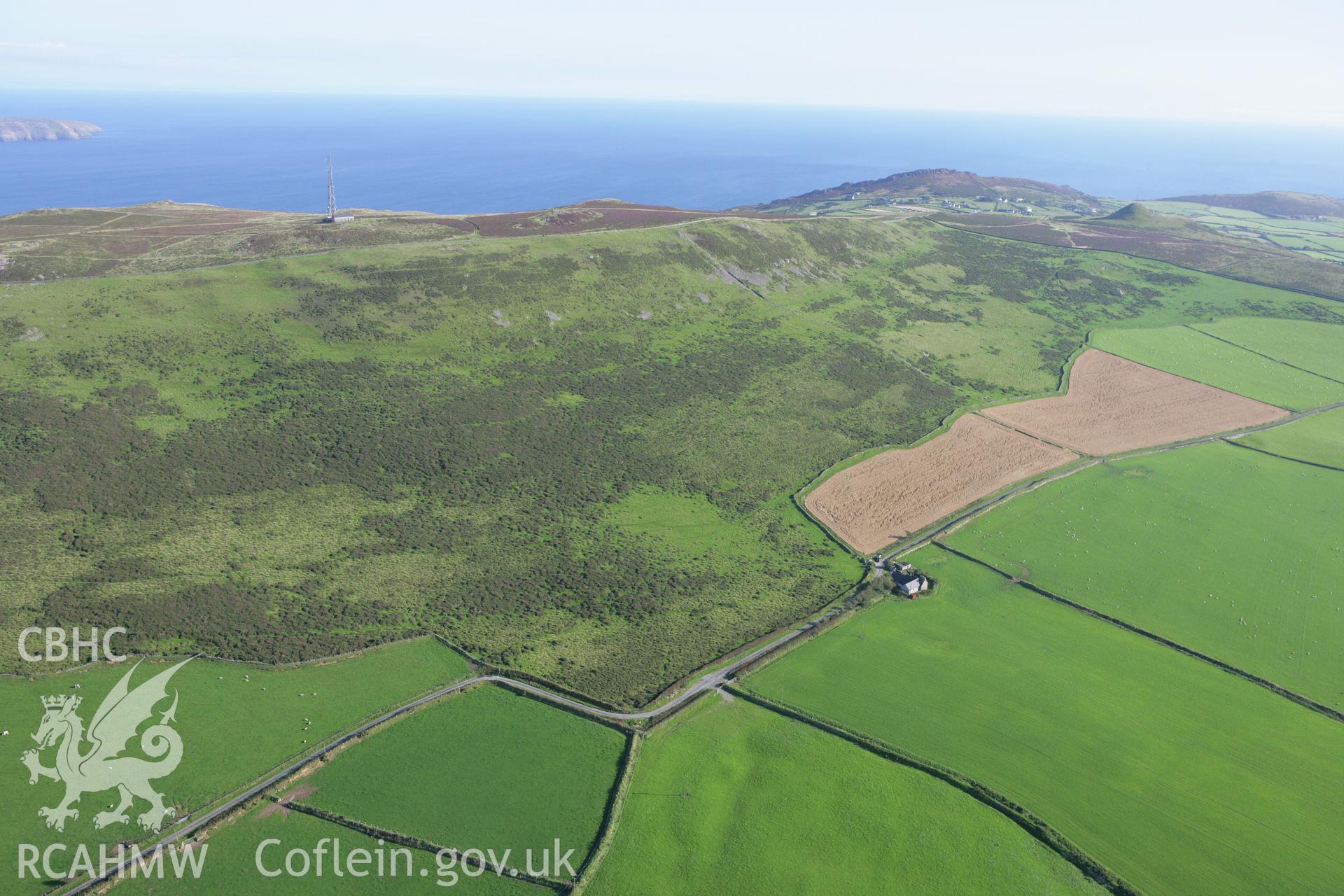 RCAHMW colour oblique aerial photograph showing landscape of Neolithic Axe Factory, Mynydd Rhiw. Taken on 06 September 2007 by Toby Driver