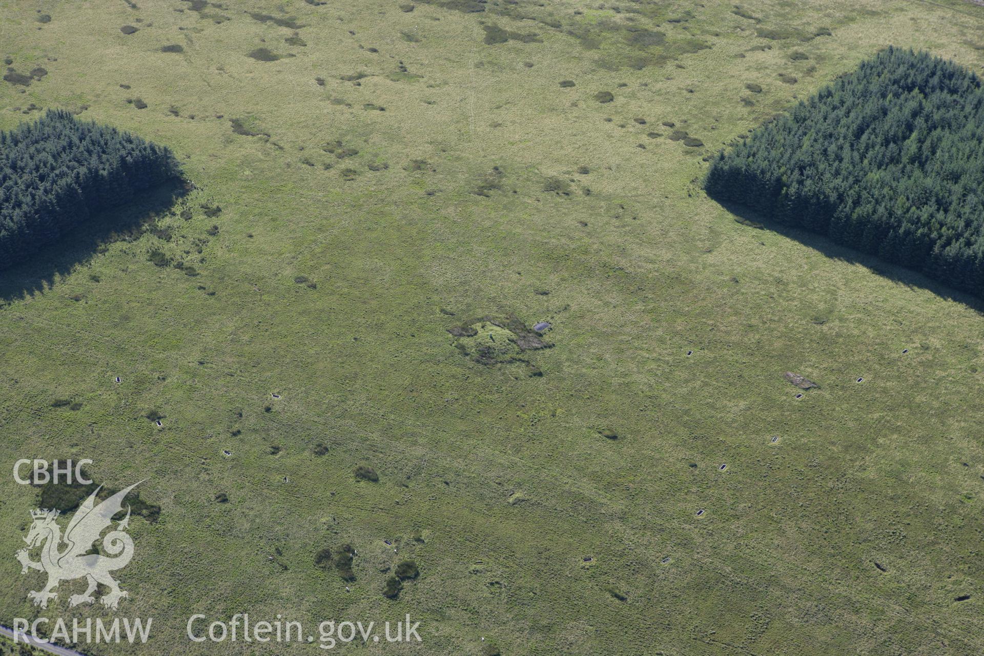 RCAHMW colour oblique aerial photograph of Ffynnon Dafydd Befan Cairn II. Taken on 08 August 2007 by Toby Driver