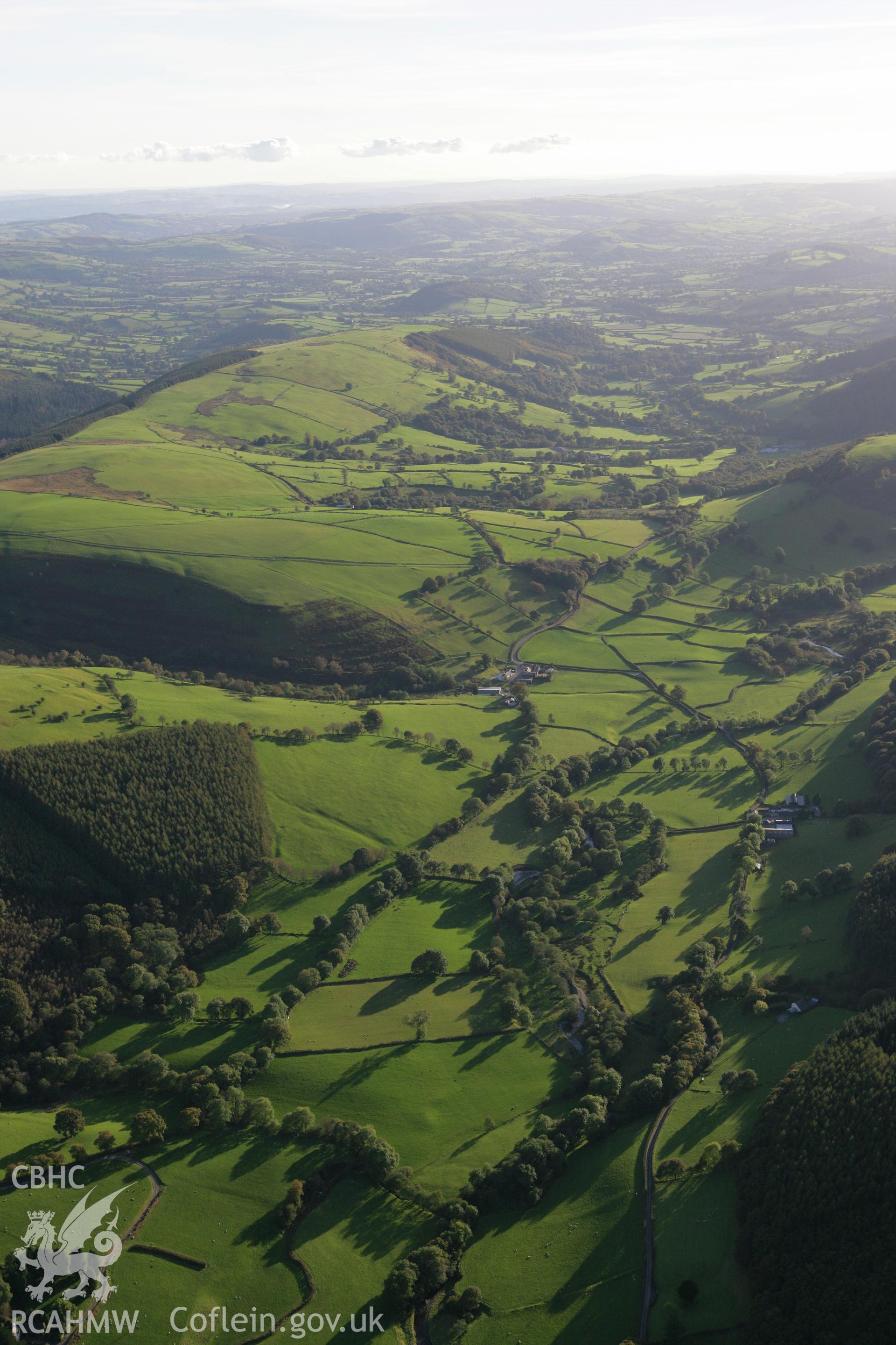 RCAHMW colour oblique photograph of Landscape south-west over Llwyn y Ceiliog. Taken by Toby Driver on 04/10/2007.