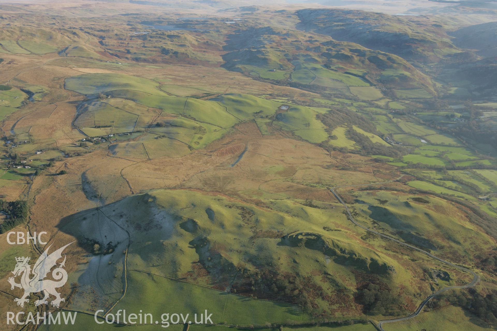 RCAHMW colour oblique photograph of Pen-y-Bannau hillfort, with landscape looking south-east to Strata Florida. Taken by Toby Driver on 20/12/2007.