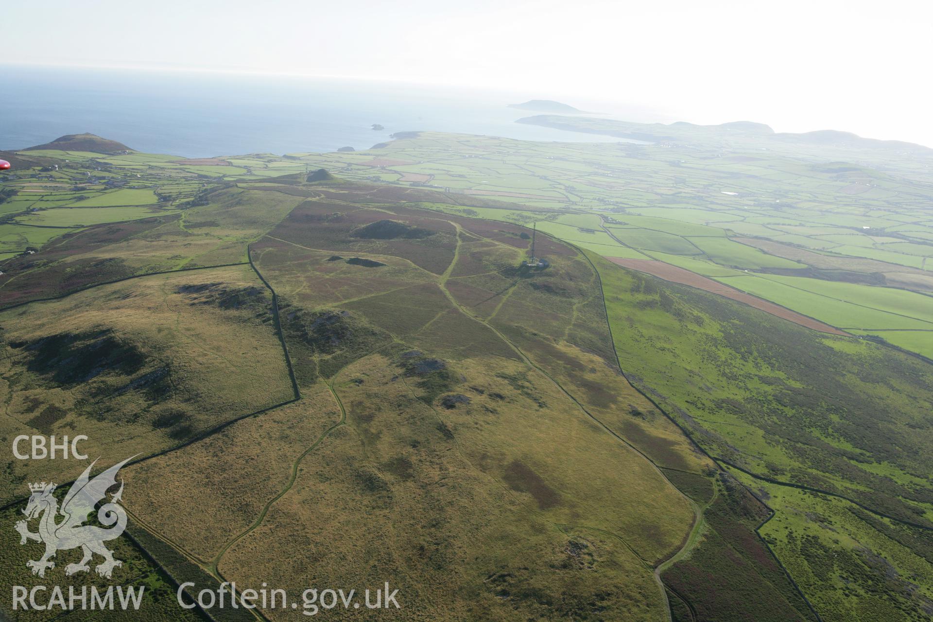 RCAHMW colour oblique aerial photograph showing landscape of Neolithic Axe Factory, Mynydd Rhiw. Taken on 06 September 2007 by Toby Driver