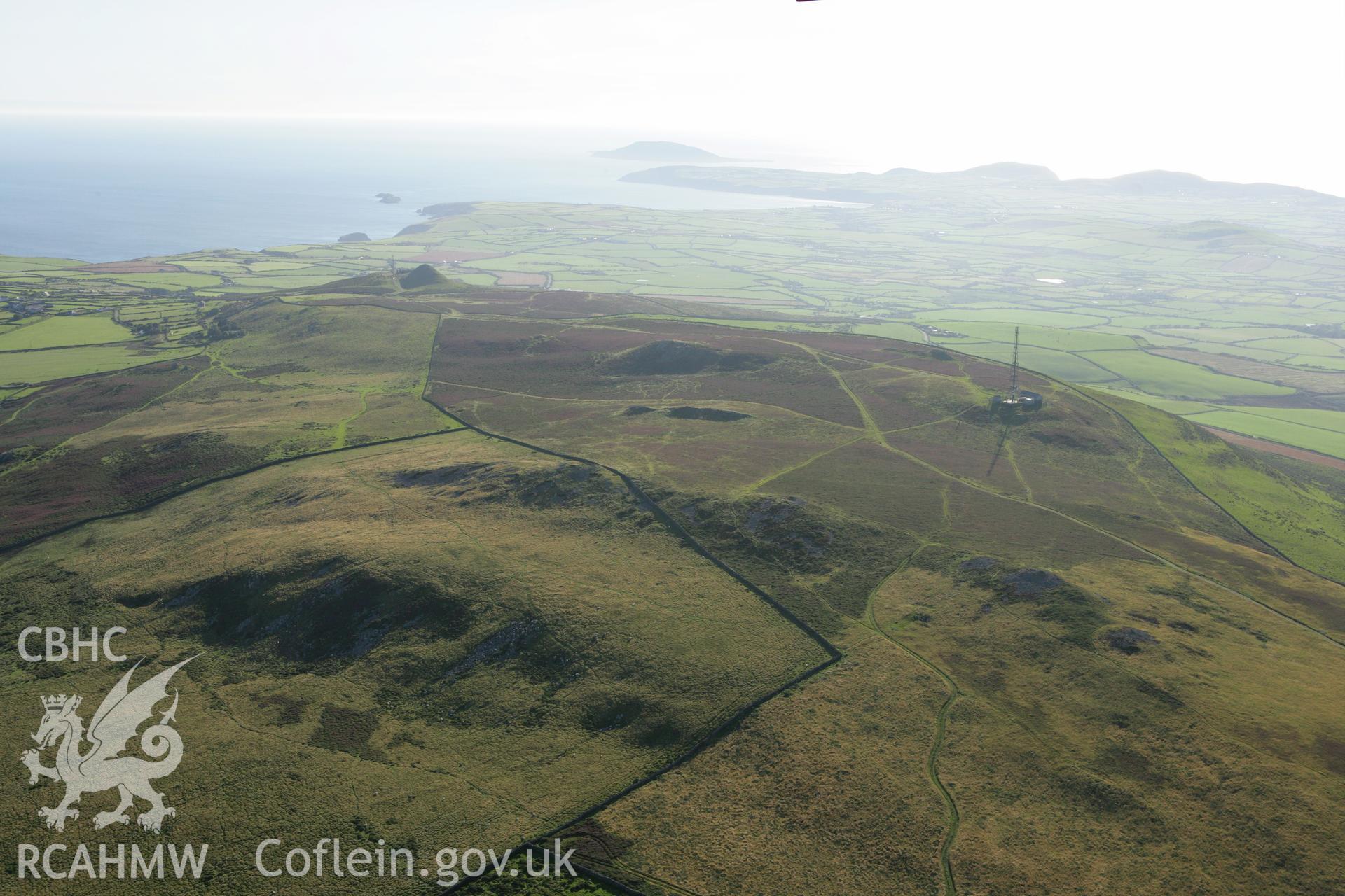 RCAHMW colour oblique aerial photograph showing landscape of Neolithic Axe Factory, Mynydd Rhiw, viewed from the east. Taken on 06 September 2007 by Toby Driver