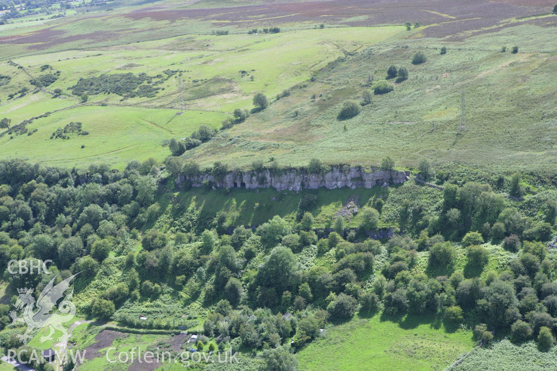 RCAHMW colour oblique aerial photograph of six vertical limekilns at Minera Quarry and the landscape to the east. Taken on 24 July 2007 by Toby Driver