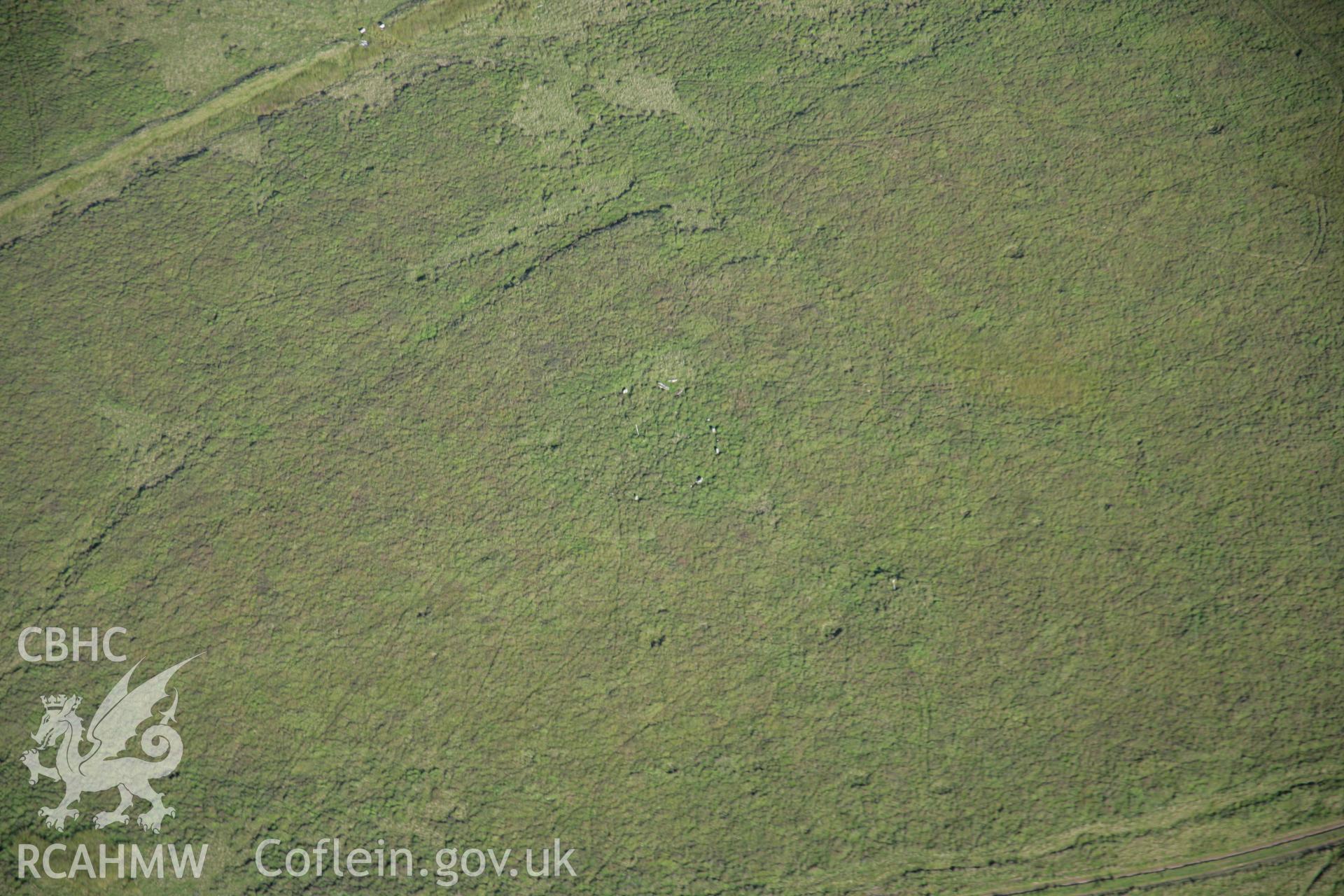 RCAHMW colour oblique aerial photograph of a stone circle west of Ynyshir. Taken on 08 August 2007 by Toby Driver