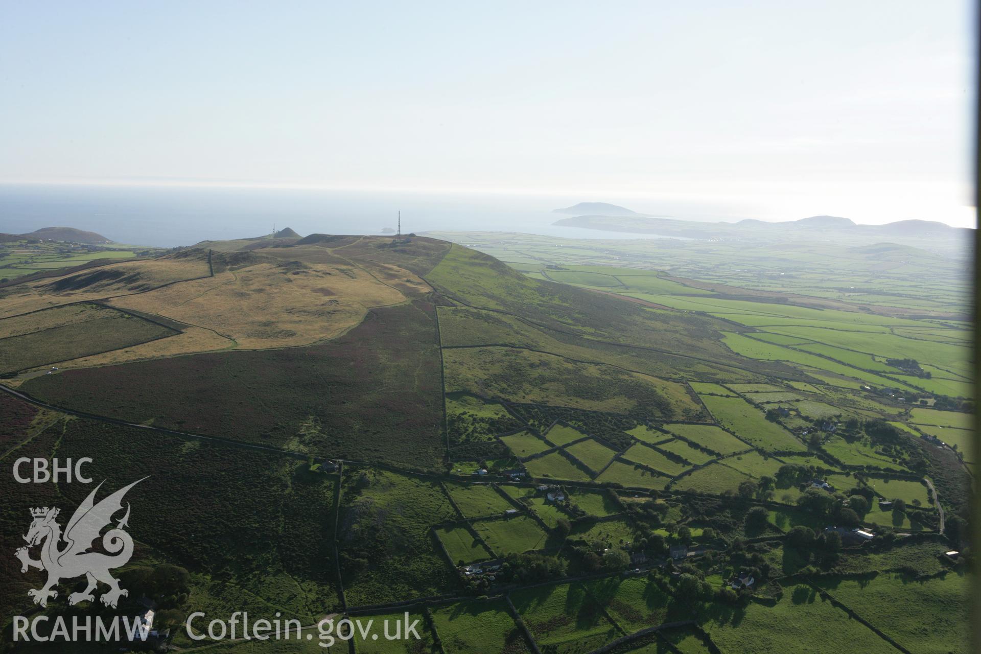 RCAHMW colour oblique aerial photograph showing landscape of Neolithic Axe Factory, Mynydd Rhiw, viewed from the north-east. Taken on 06 September 2007 by Toby Driver