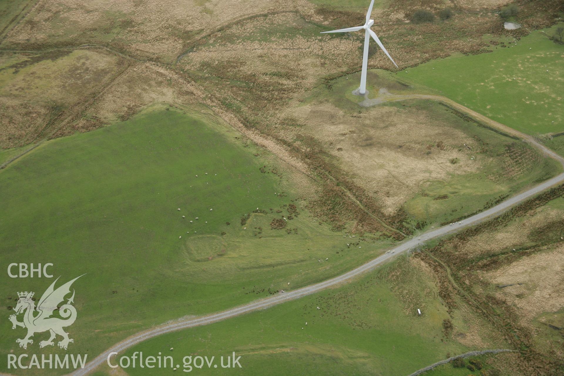 RCAHMW colour oblique aerial photograph of Banc Pwlldrainllwyn Enclosure. Taken on 17 April 2007 by Toby Driver