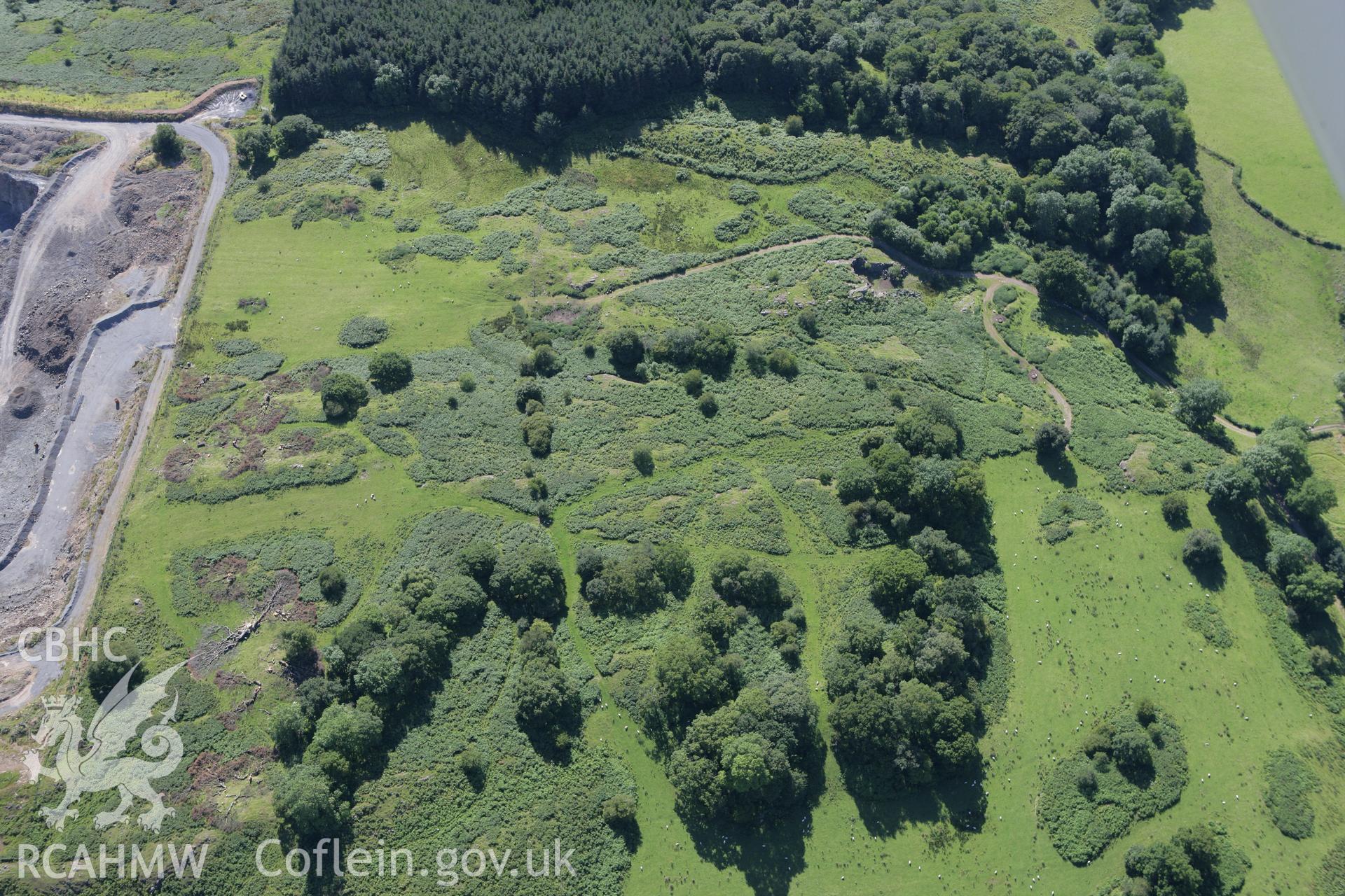 RCAHMW colour oblique aerial photograph of cairns near Llanelwedd quarry. Taken on 08 August 2007 by Toby Driver