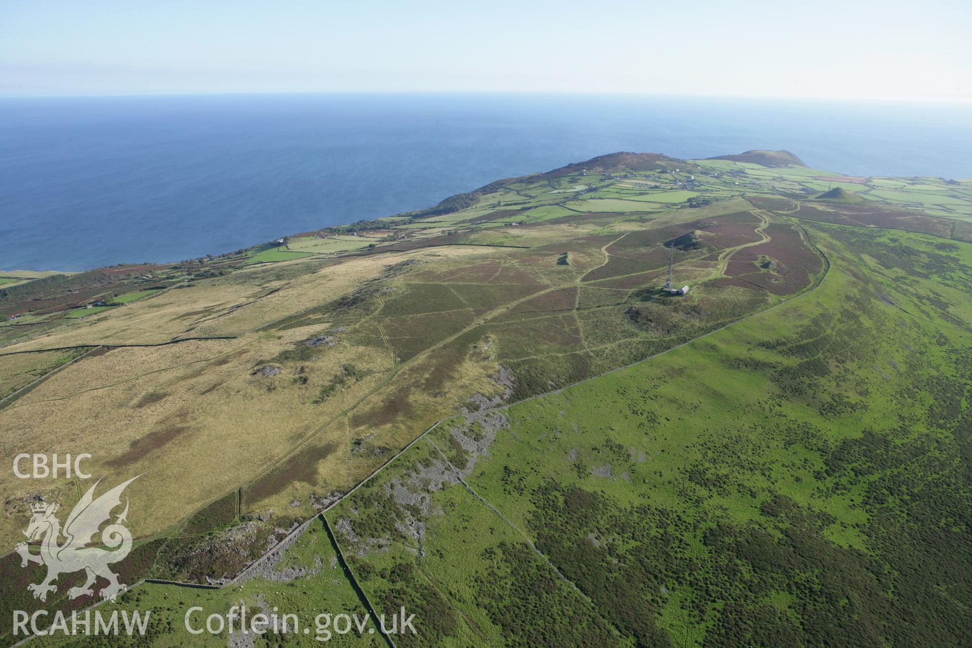 RCAHMW colour oblique aerial photograph showing landscape of Neolithic Axe Factory, Mynydd Rhiw, viewed from the north. Taken on 06 September 2007 by Toby Driver