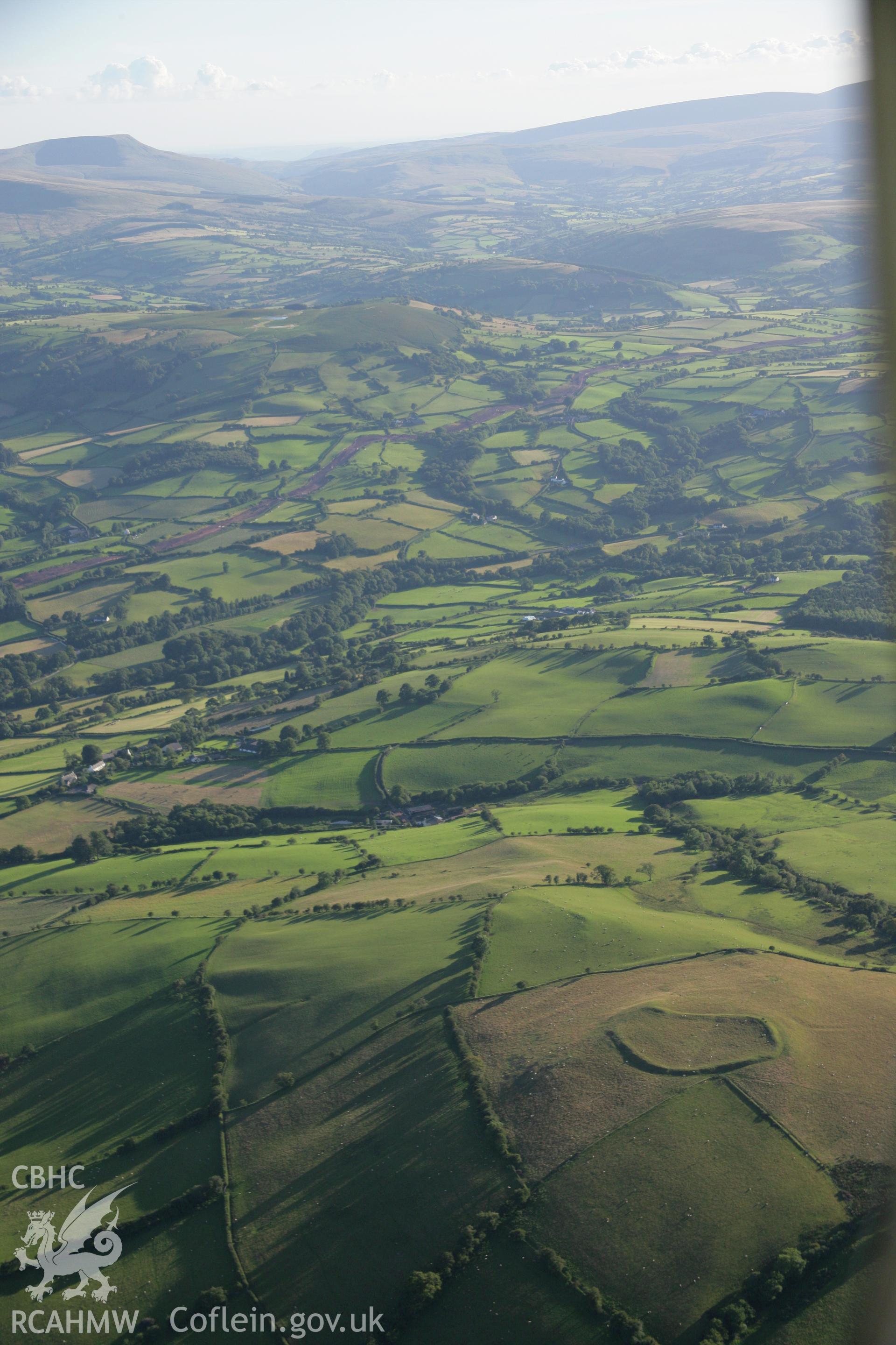 RCAHMW colour oblique aerial photograph of Twyn-y-Gaer Settlement, Trallwng. Taken on 08 August 2007 by Toby Driver