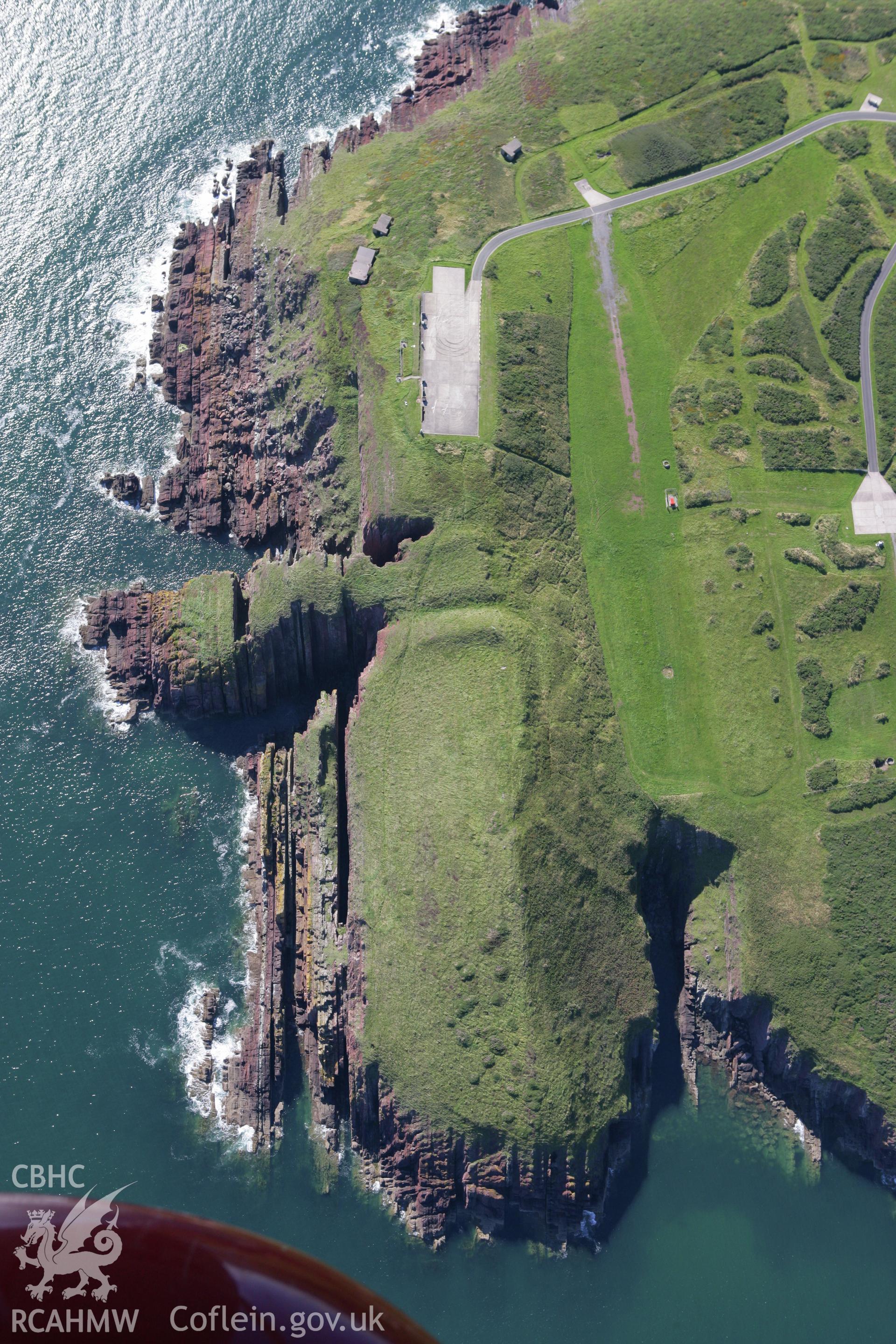 RCAHMW colour oblique aerial photograph of Old Castle Head Promontory Fort. Taken on 30 July 2007 by Toby Driver