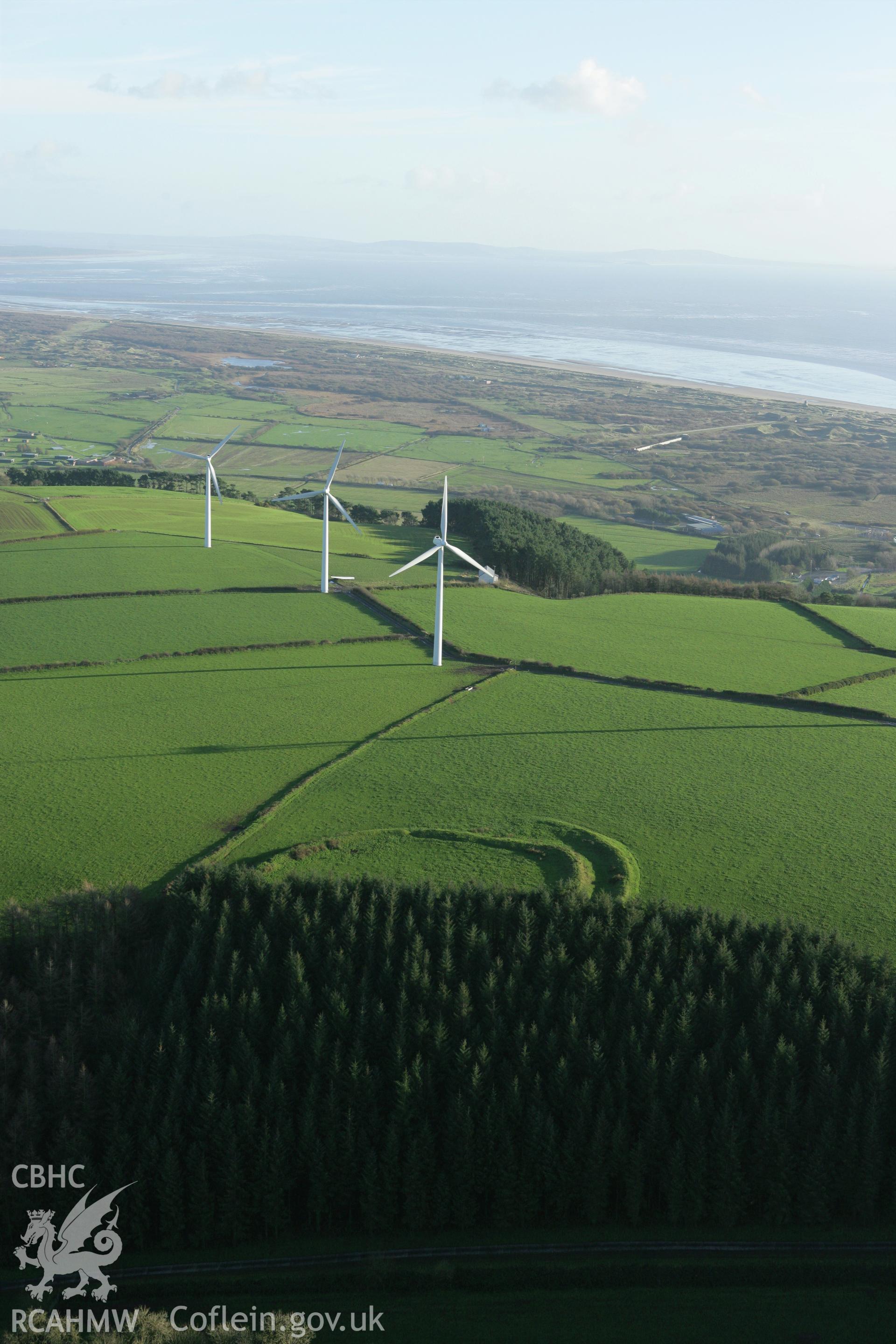 RCAHMW colour oblique photograph of Parc Cynog Farm hillfort;Wind Farm, Llanimiloe. Taken by Toby Driver on 29/11/2007.