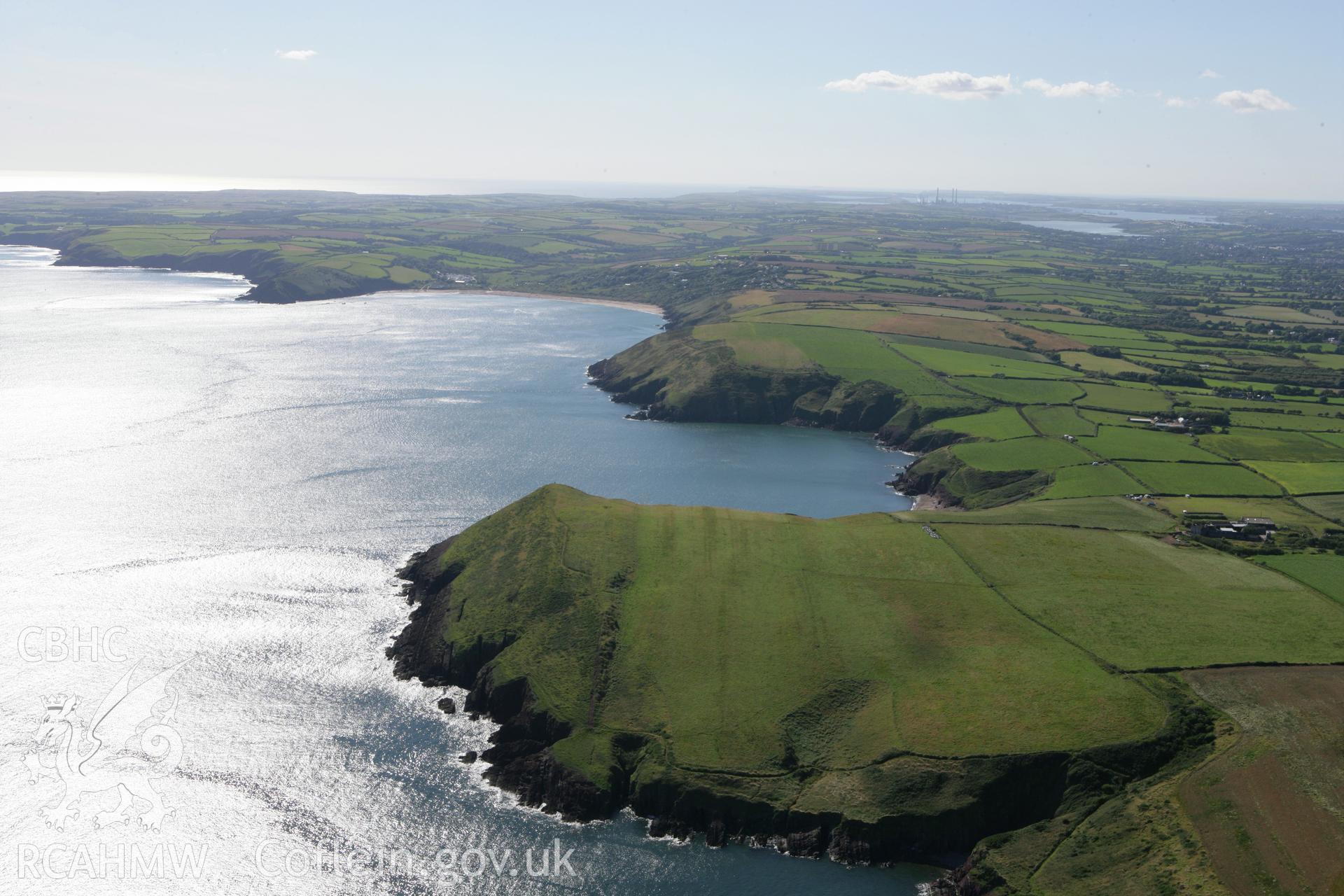 RCAHMW colour oblique aerial photograph of King's Quoit Burial Chamber landscape viewed west from Manorbier. Taken on 30 July 2007 by Toby Driver