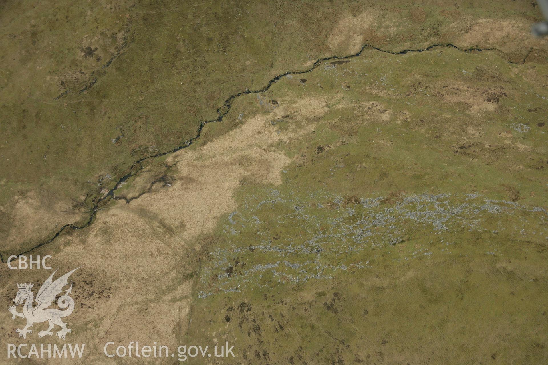 RCAHMW colour oblique aerial photograph of a hut circle settlement below Foel Isaf, Bugeilyn. Taken on 17 April 2007 by Toby Driver