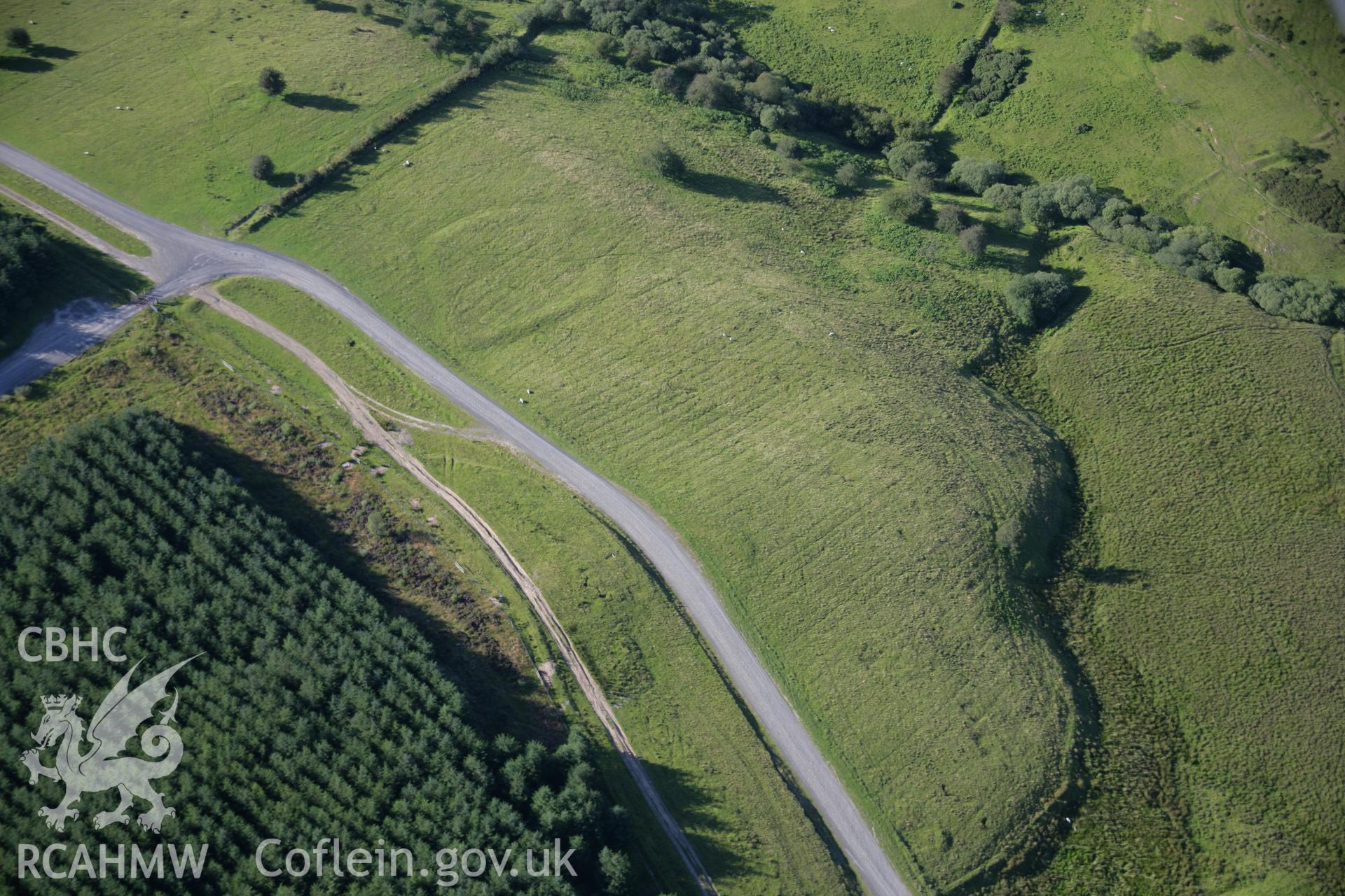 RCAHMW colour oblique aerial photograph of Dixies Corner Enclosure, Llandeilor Fan. Taken on 08 August 2007 by Toby Driver