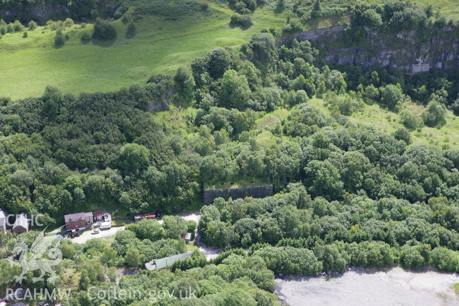 RCAHMW colour oblique aerial photograph of six vertical limekilns at Minera Quarry. Taken on 24 July 2007 by Toby Driver