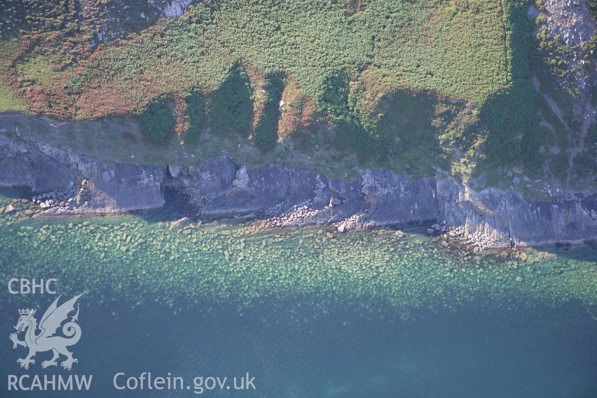 RCAHMW colour oblique aerial photograph of non-archaeological view of eroding cliff, Trwyn Llech y Doll, near Chambered Tomb Cilan Uchaf. Taken on 06 September 2007 by Toby Driver