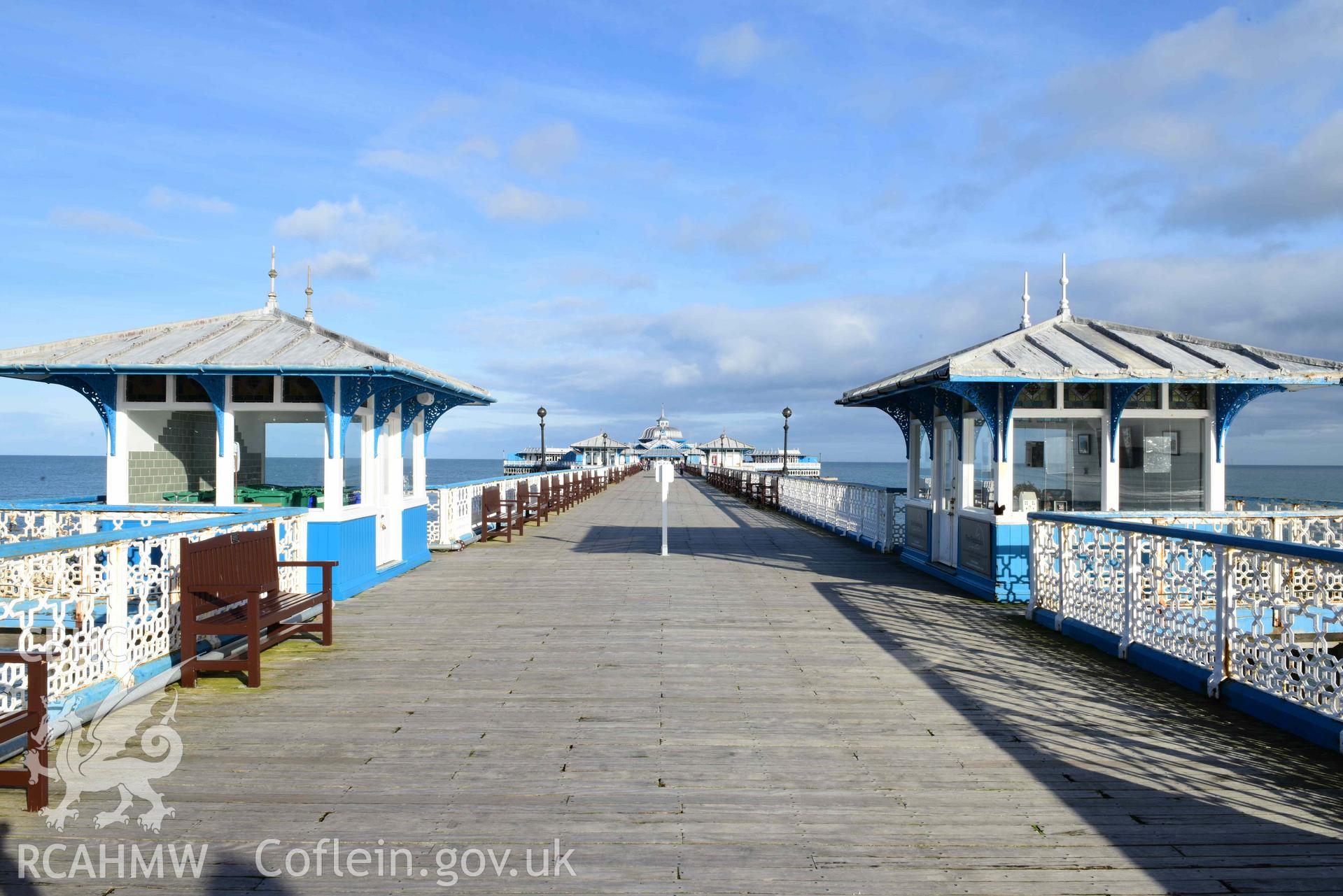 Llandudno Pier: view north-east along length of pier boardwalk, with central pair of kiosks