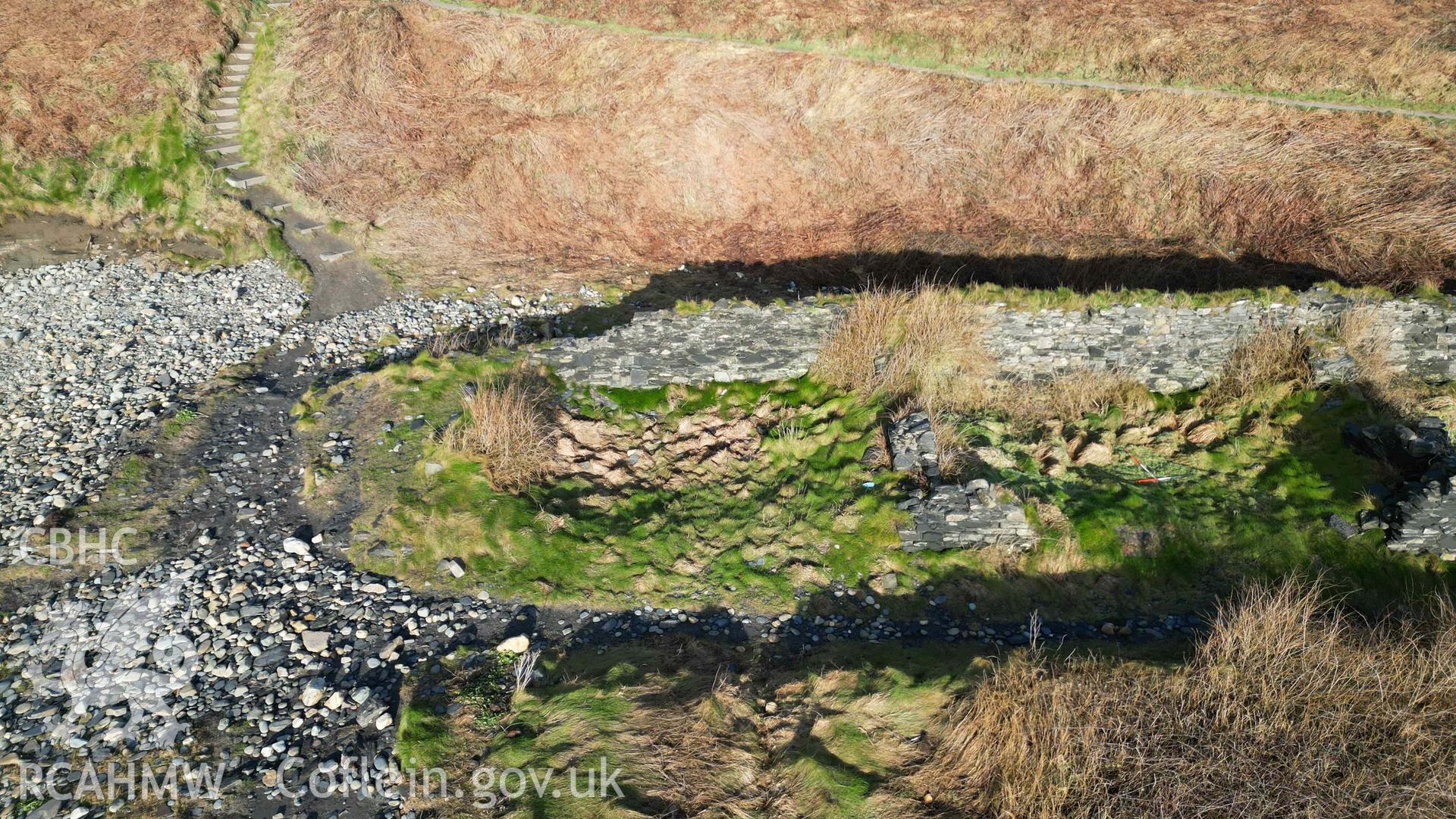 Oblique view, looking north, of Cottages 1 to 3 at Abereiddi/Abereiddy on 11/12/2024. Cottage 1 is to the left, severely impacted by erosion. Cottage 2 is in the centre, Cottage 3 to the right with 1m scale bars within it.