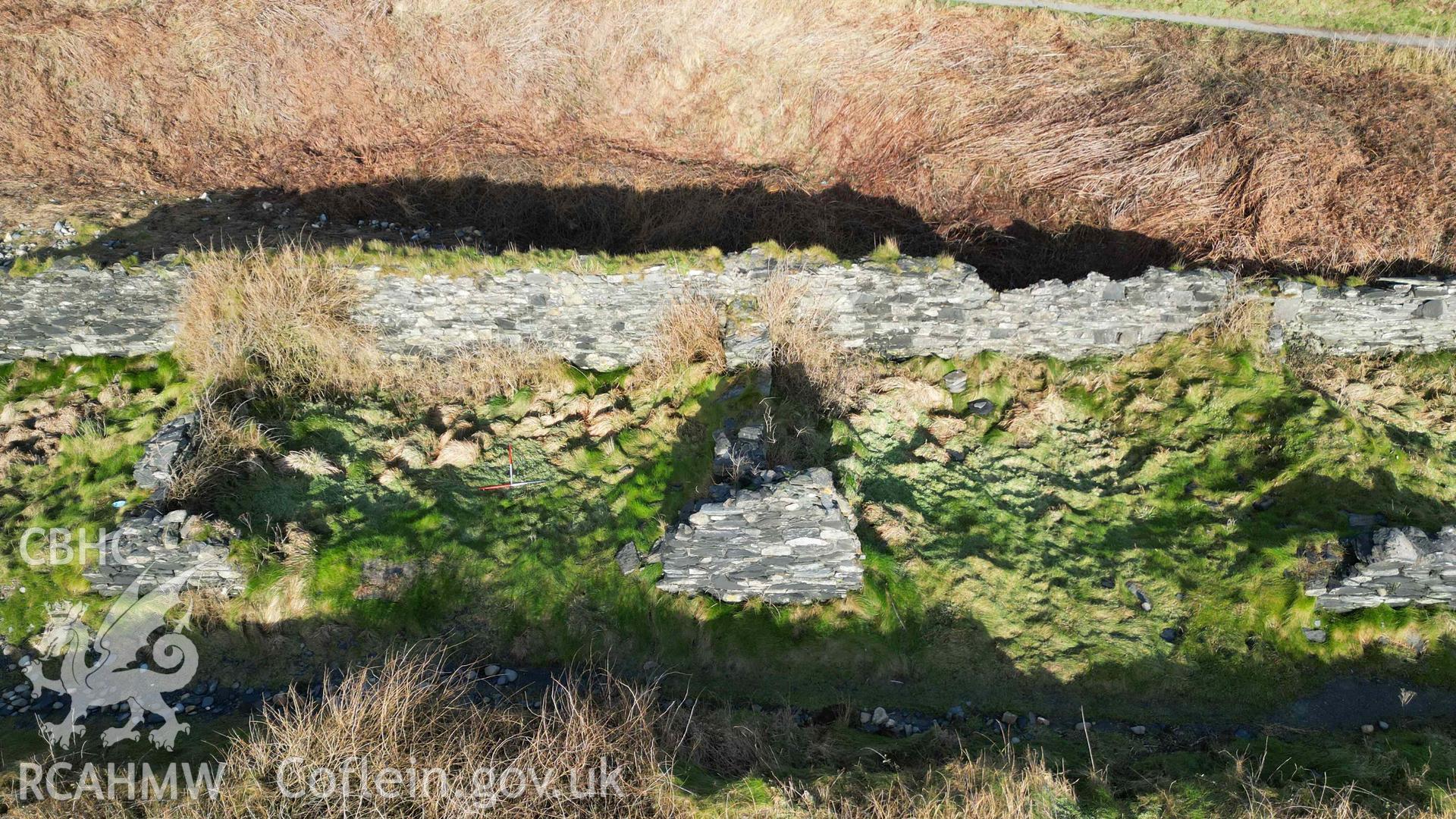 Oblique view, looking north, of Cottages 3 and 4 at Abereiddi/Abereiddy on 11/12/2024. Cottage 3 to the left with 1m scale bars within it. Cottage 4 is to the right.