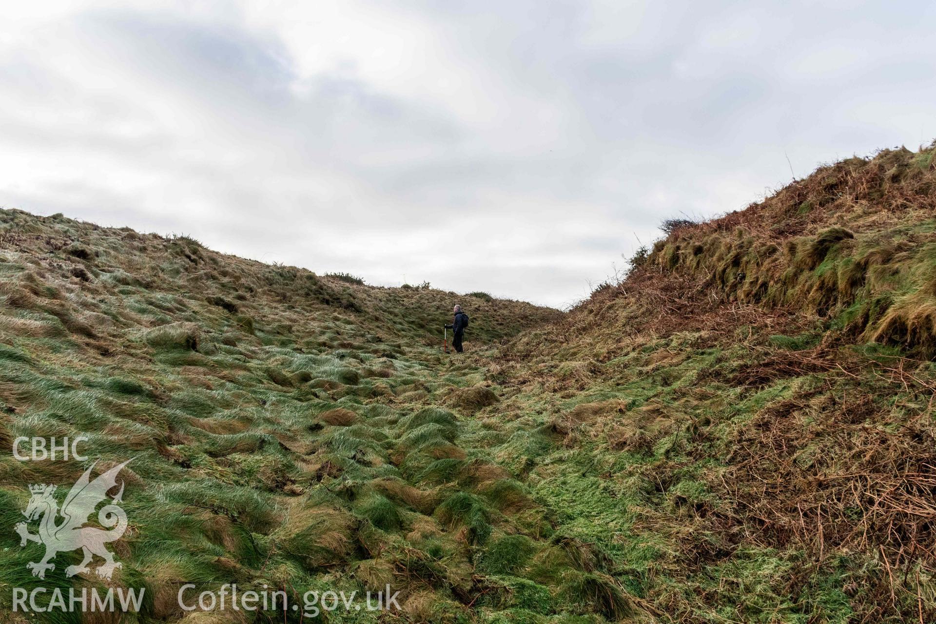 Caer Aber Pwll coastal promontory fort. Looking south along inner ditch defining the east side of the fort (with scale).