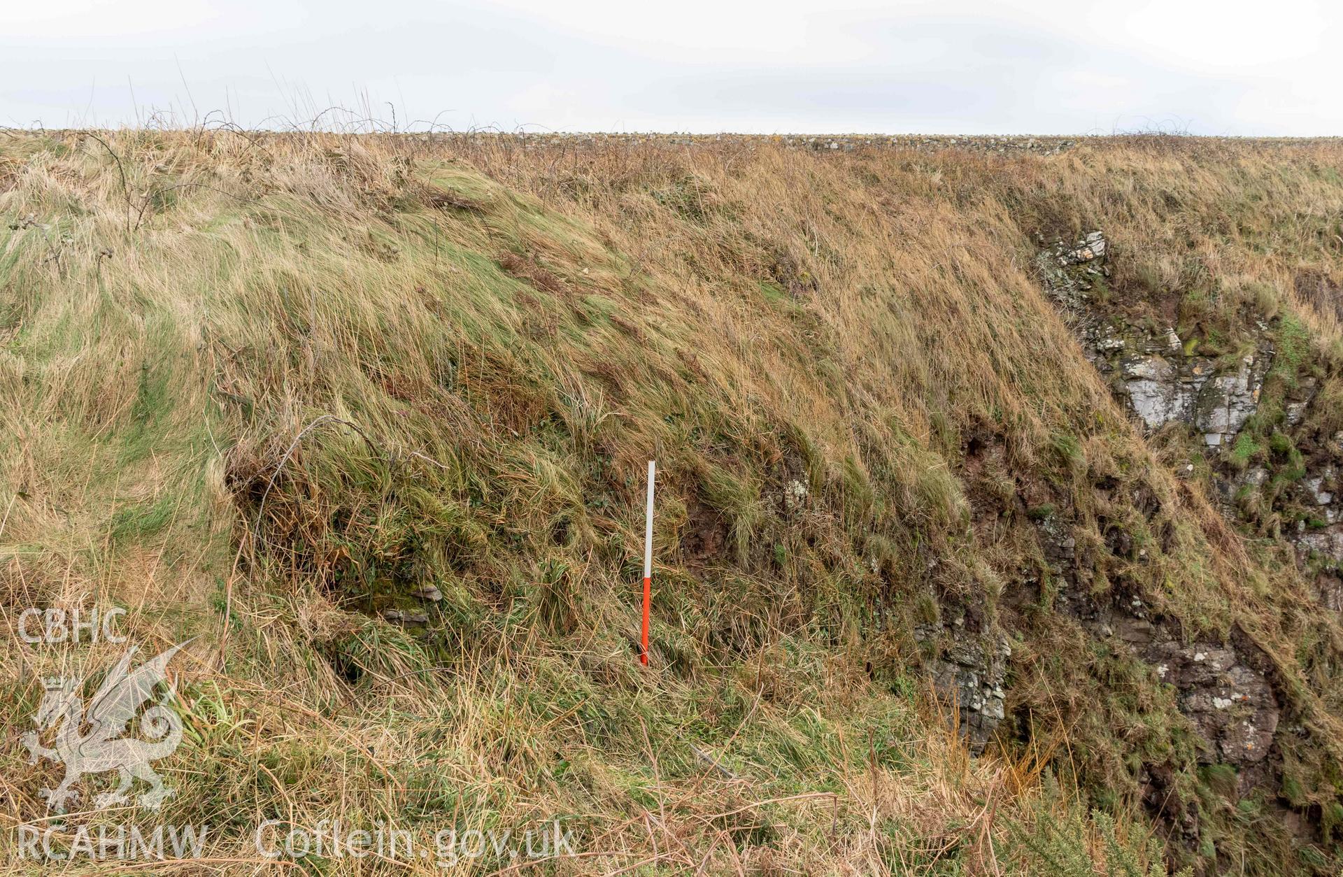 Castle Head Coastal Promontory Fort. Quarried edge of outer rock cut ditch (with scale).