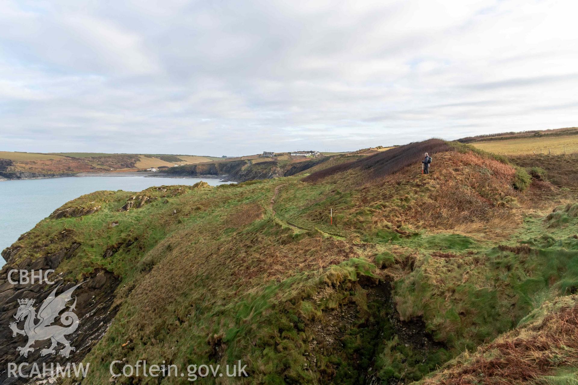 Little Aber Pwll coastal promontort fort. Looking east across to promontory fort and the substantial defensive bank defining the fort's interior (with scale).